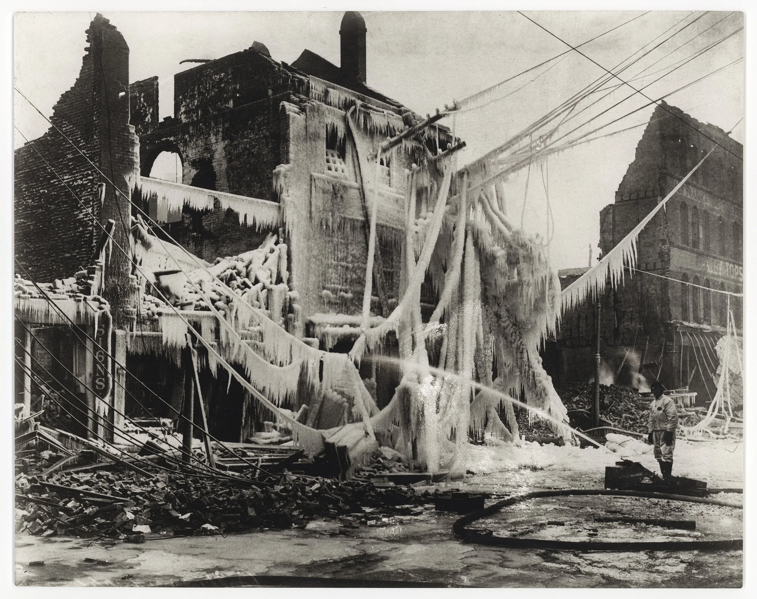 "Fire Fighter Extinguishing Fire in Winter, 1900's"