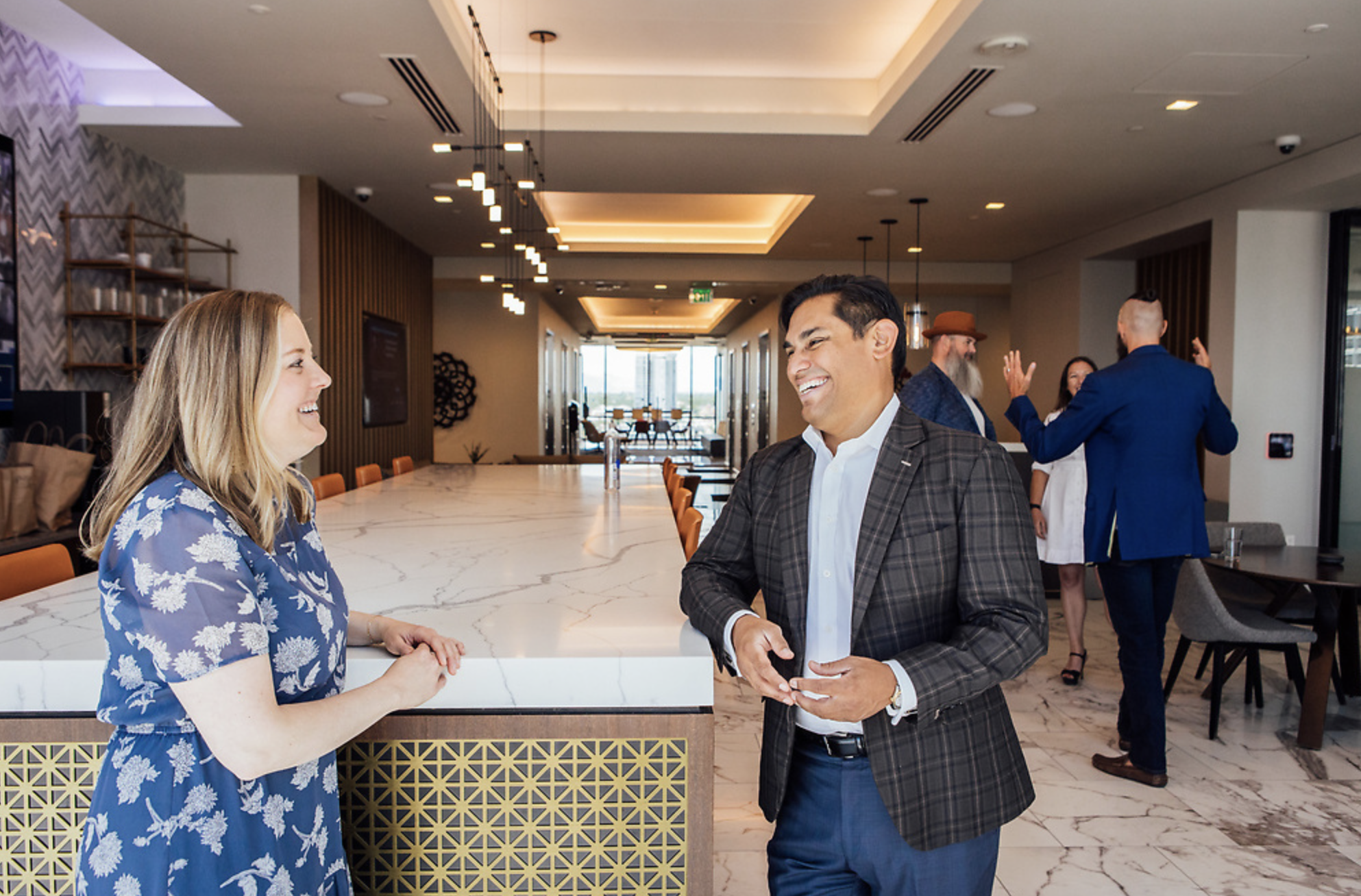 A man and woman smiling mid conversation in the Firestorm office