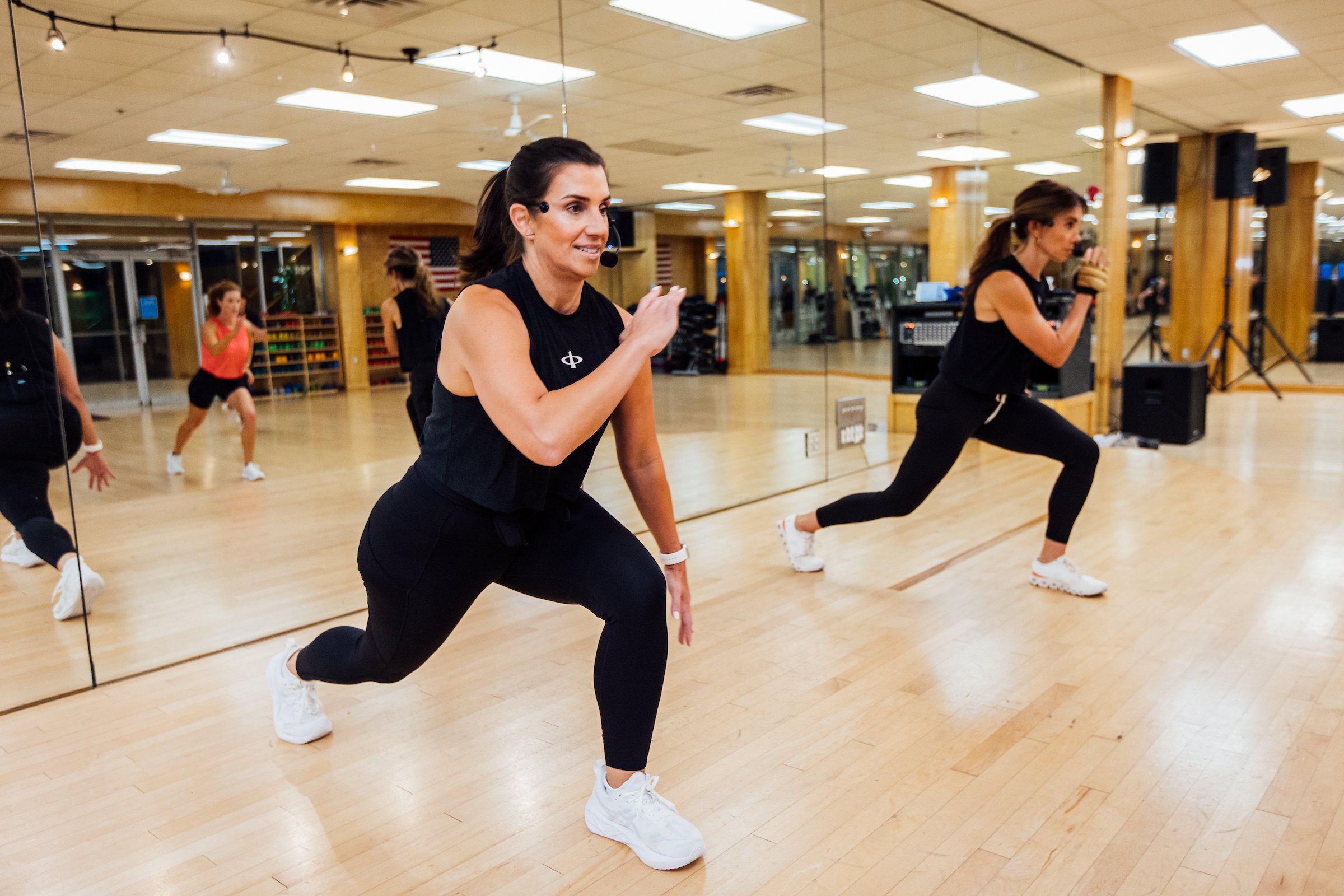 Instructors lead workout class in running position