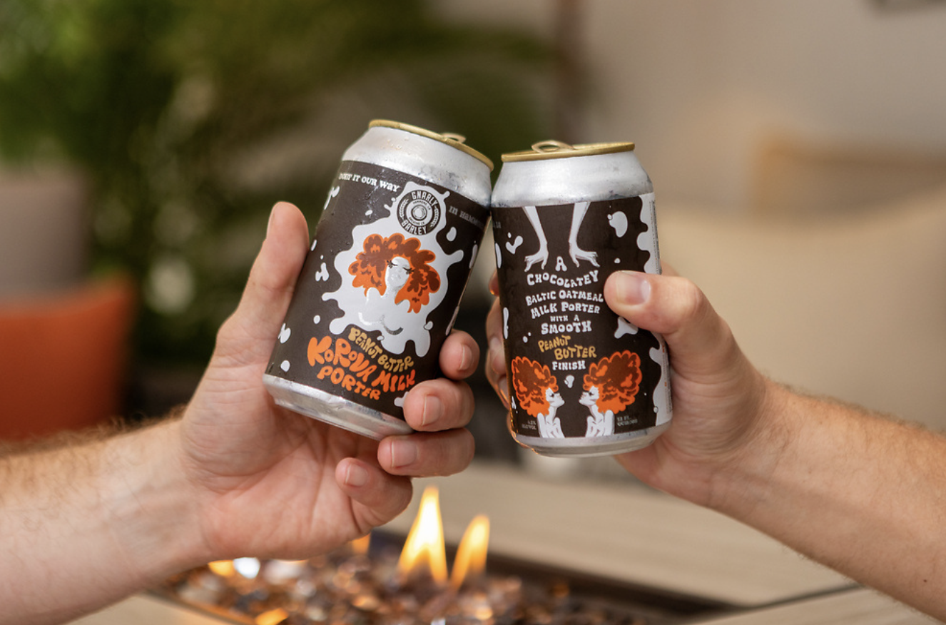 Two beers in front of a fire