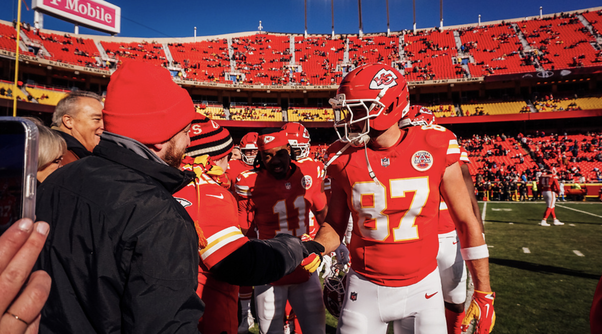 Travis Kelce shakes Bradley's hand on the sidelines at Arrowhead Stadium