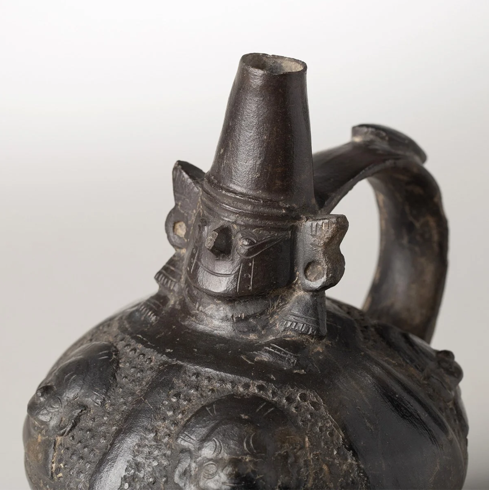Chimu Blackware Stirrup Vessel with Figure at Neck