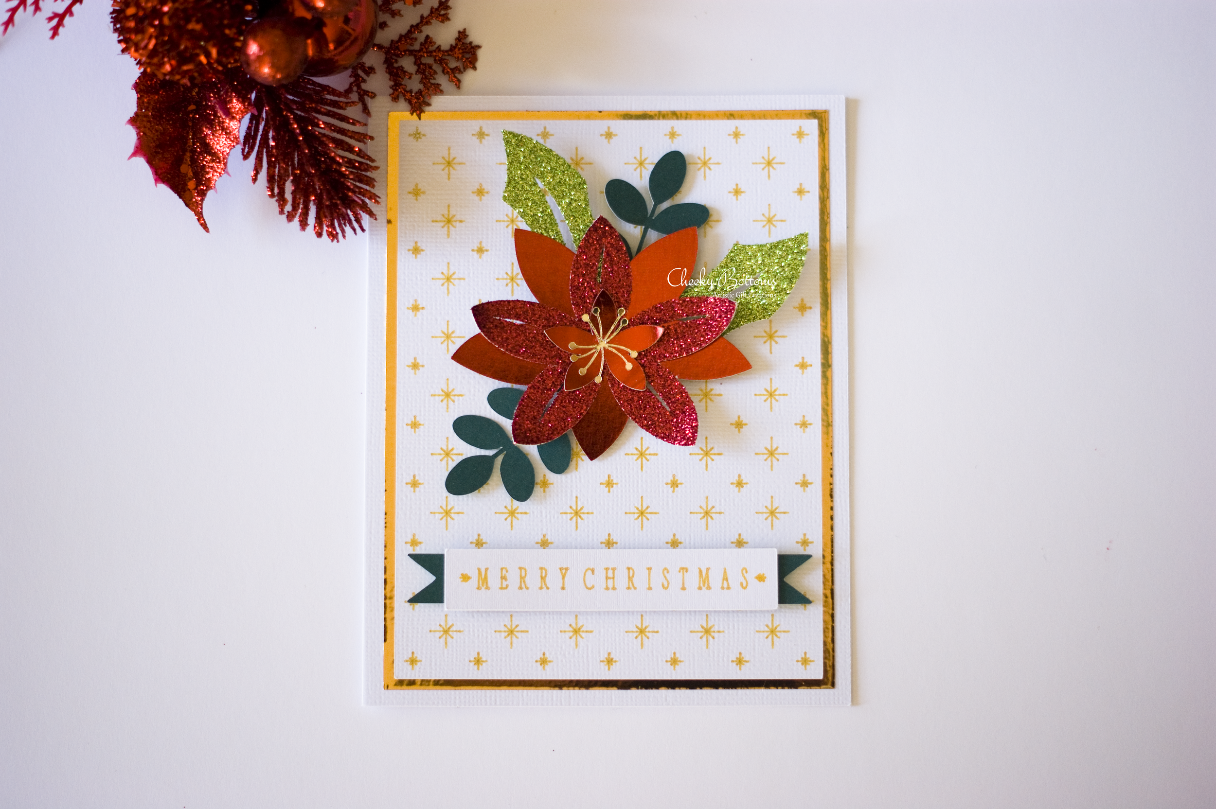 Merry Christmas greeting card made with a combination of glitter cardstock and Cricut glitter gel pens. 