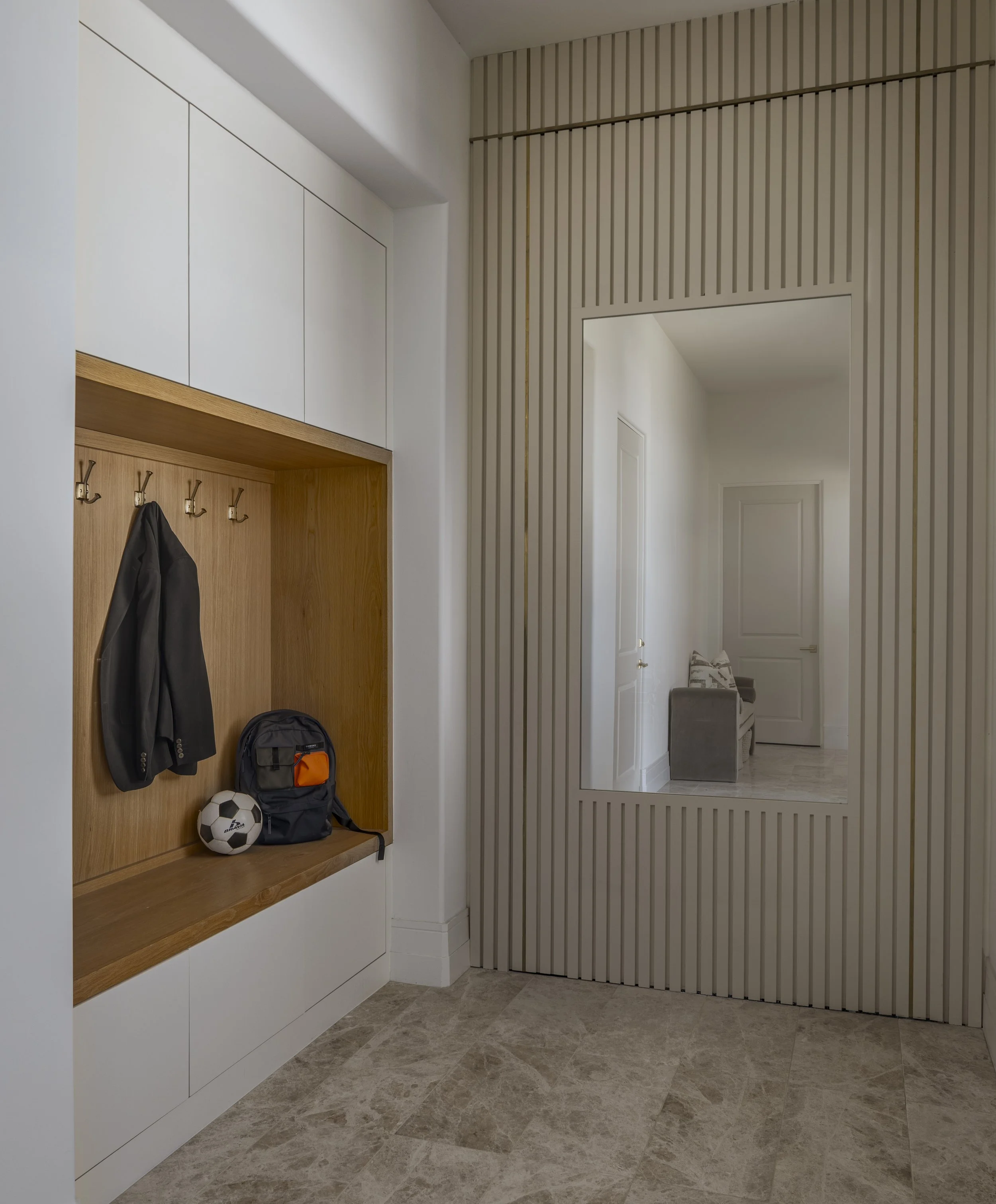 Back door drop-zone with custom cabinetry and hidden door