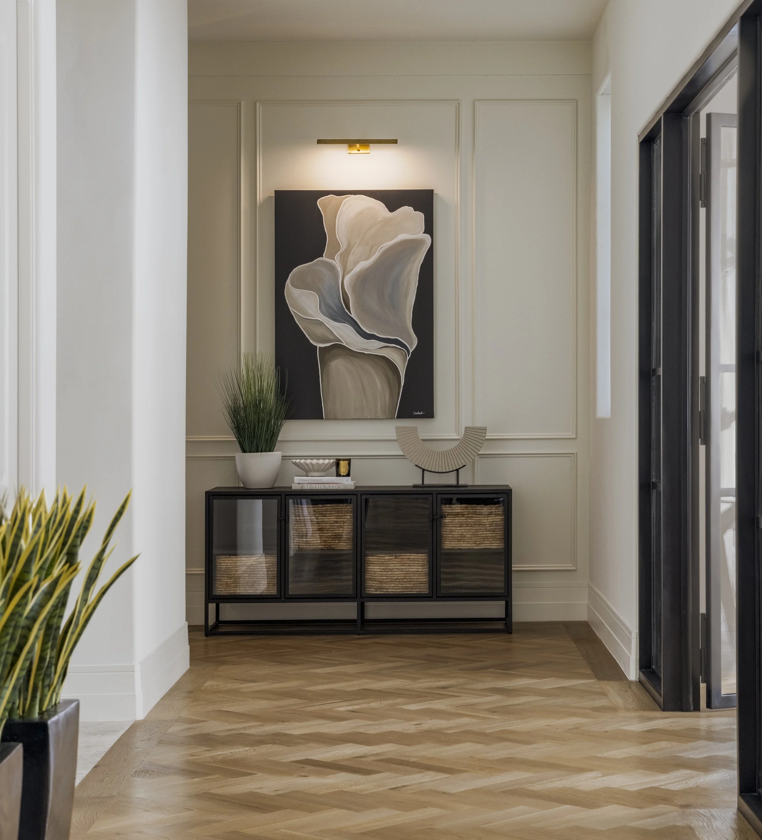 Large wall art is focal point in long hallway