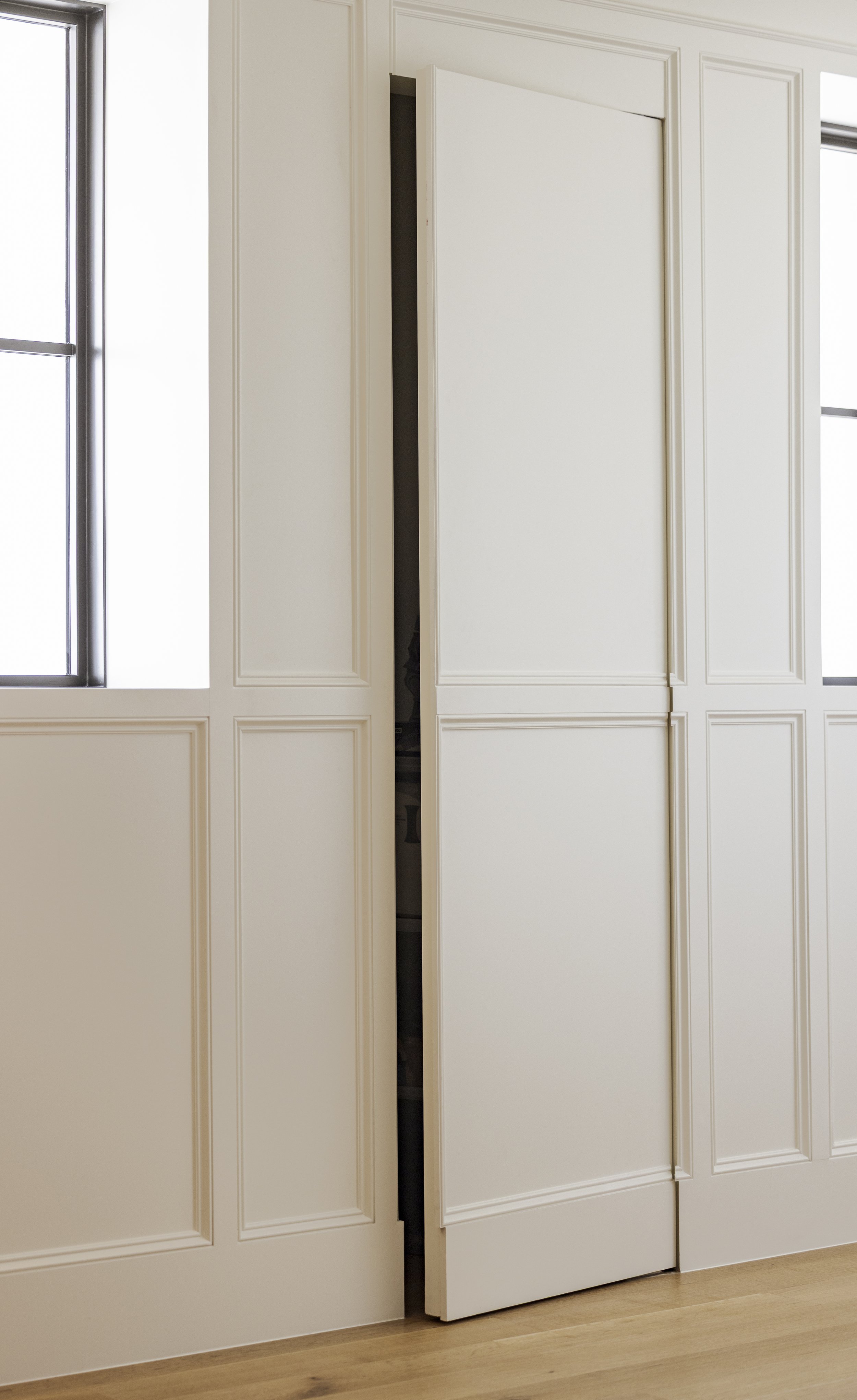 Hidden storage in hallway wall panel