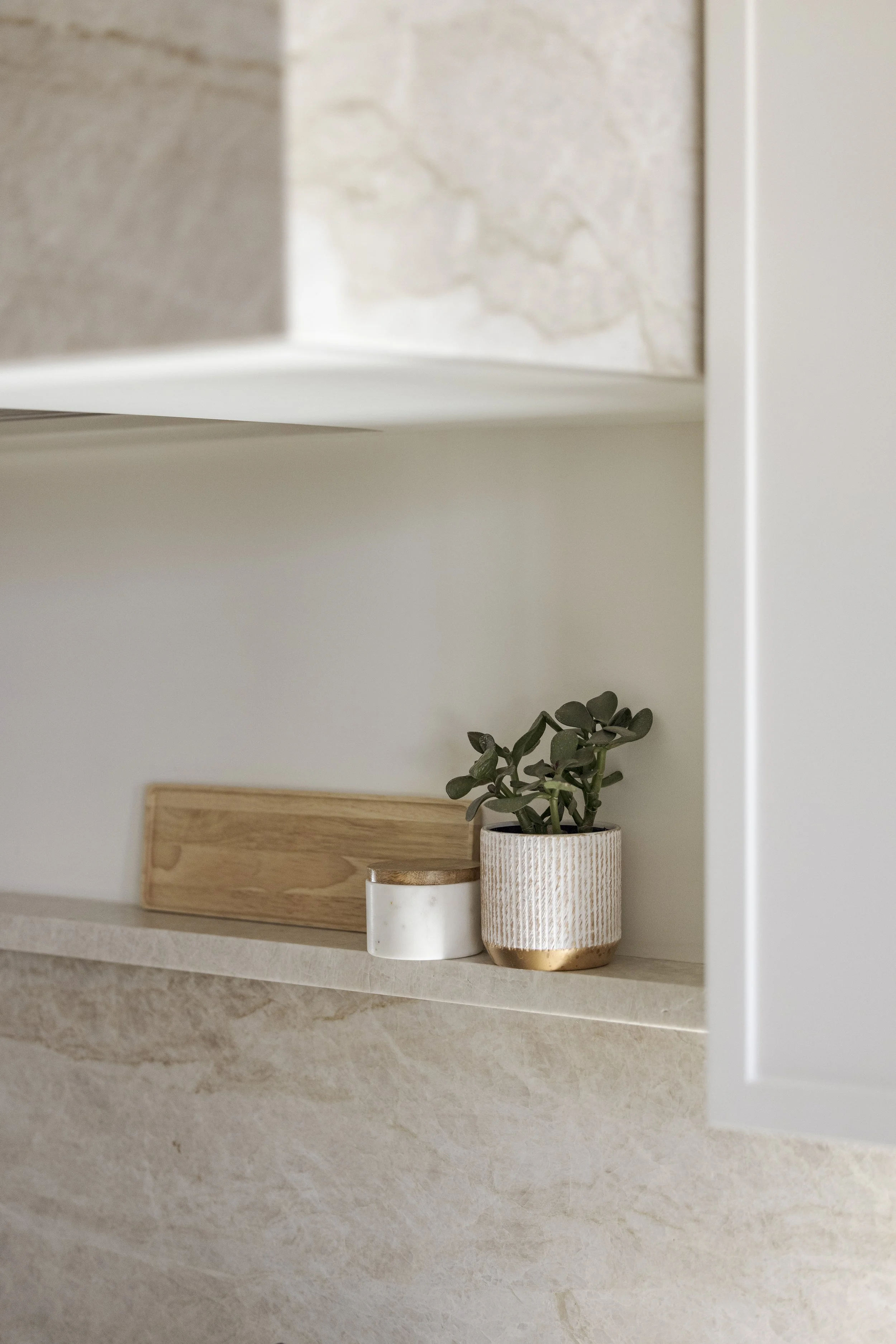 Custom integrated shelf above cooktop