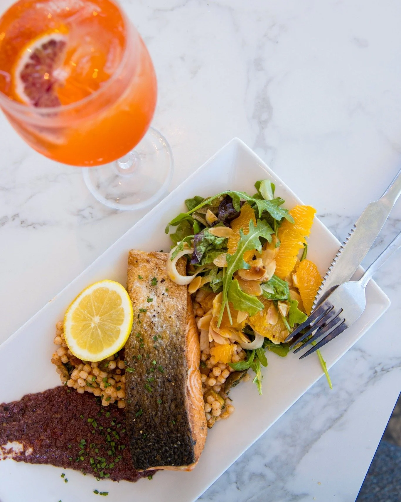Fresh spring flavours abound... ⚓️ Our GRILLED ATLANTIC SALMON FILLET 
with olive tapenade, rocket, shaved fennel, orange &amp; toasted almond salad, dressed with honey vinaigrette, and served with Israeli cous cous is a winner, that's for sure! 🍊 ?