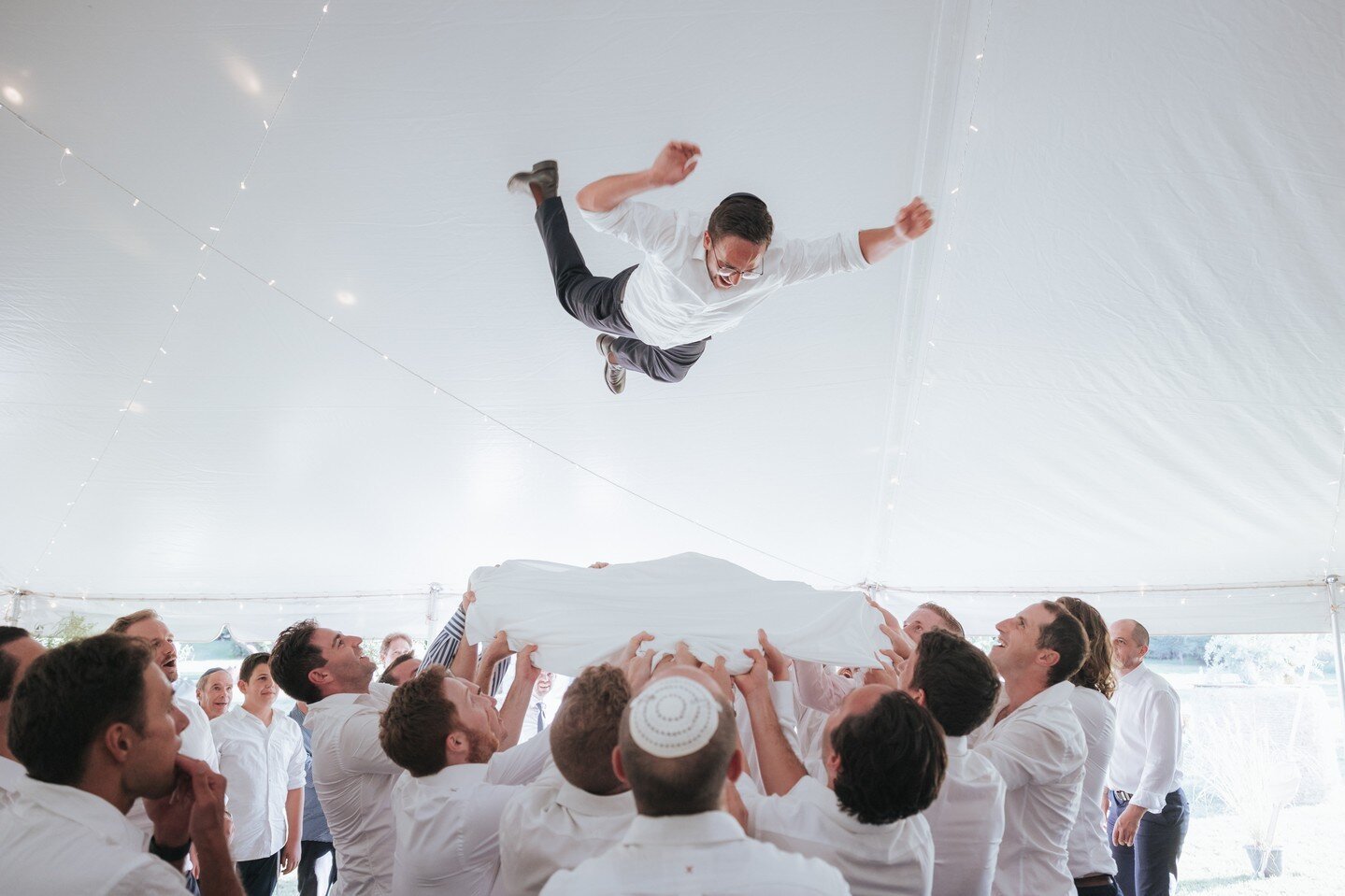 Nothing quite captures the energy and excitement of this wedding like this epic photo of the groom being launched in the air by his buddies! Hosted in Mudgee this traditional Jewish celebration got a little rowdy!