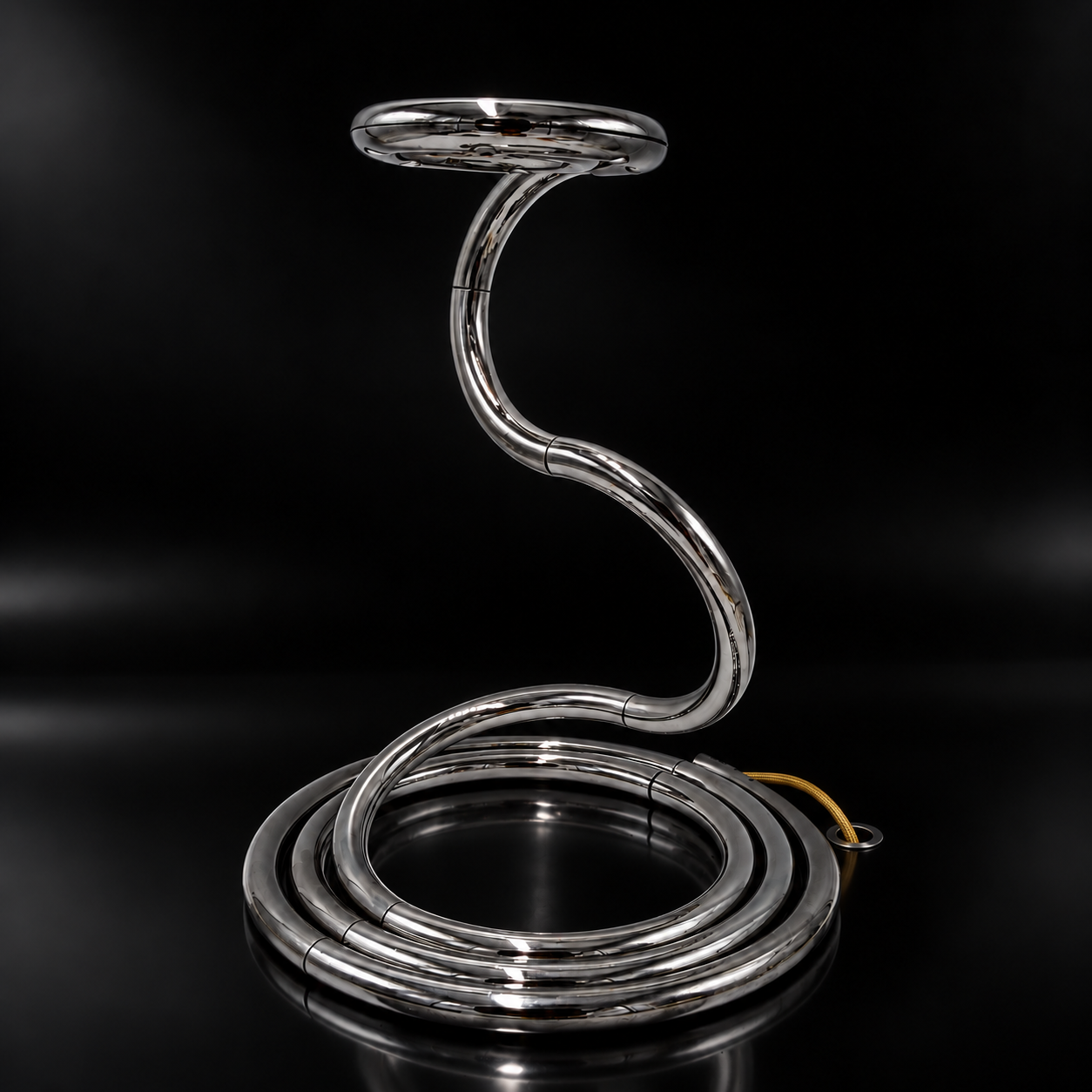Sleek Chrome Spiral Lamp on Black Surface.png