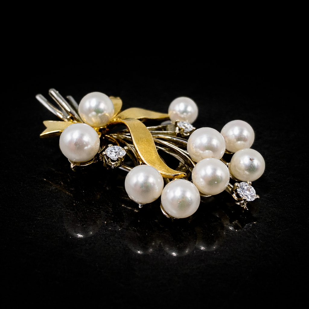 Elegant gold and pearl brooch.png