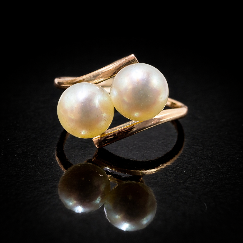Elegant double pearl ring in rose gold.png