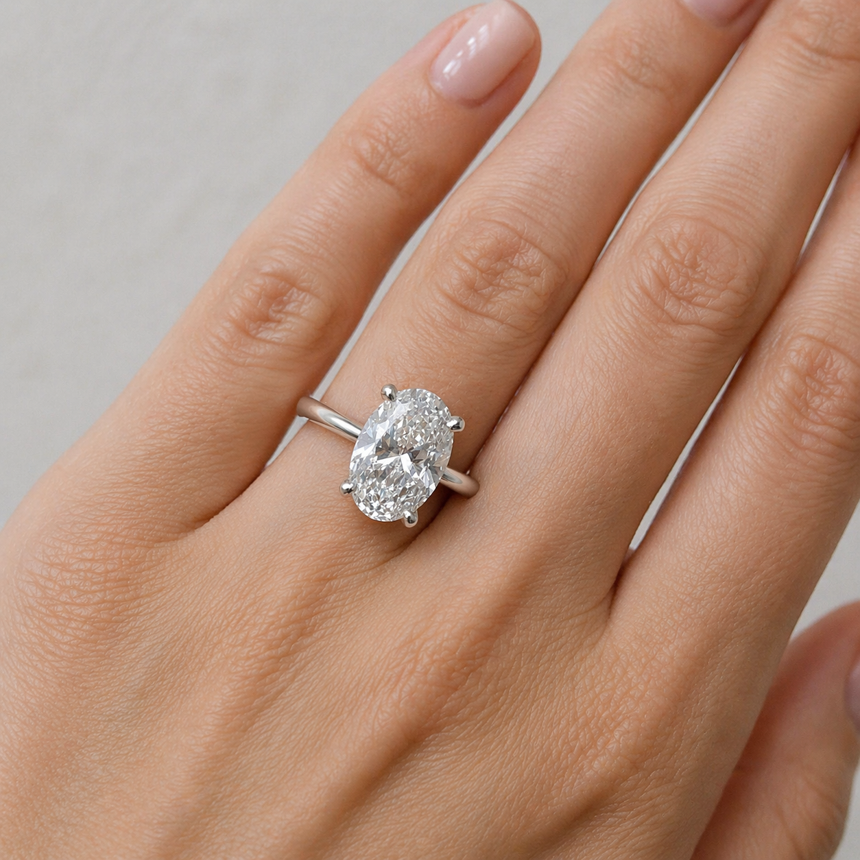 Elegant hand with diamond ring.png