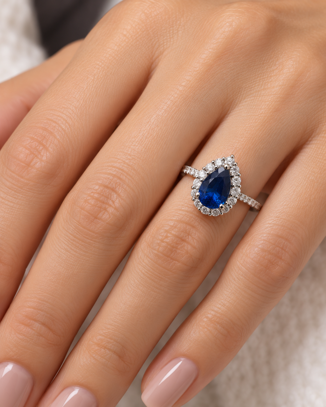 Pear Sapphire Halo Ring on Hand.png