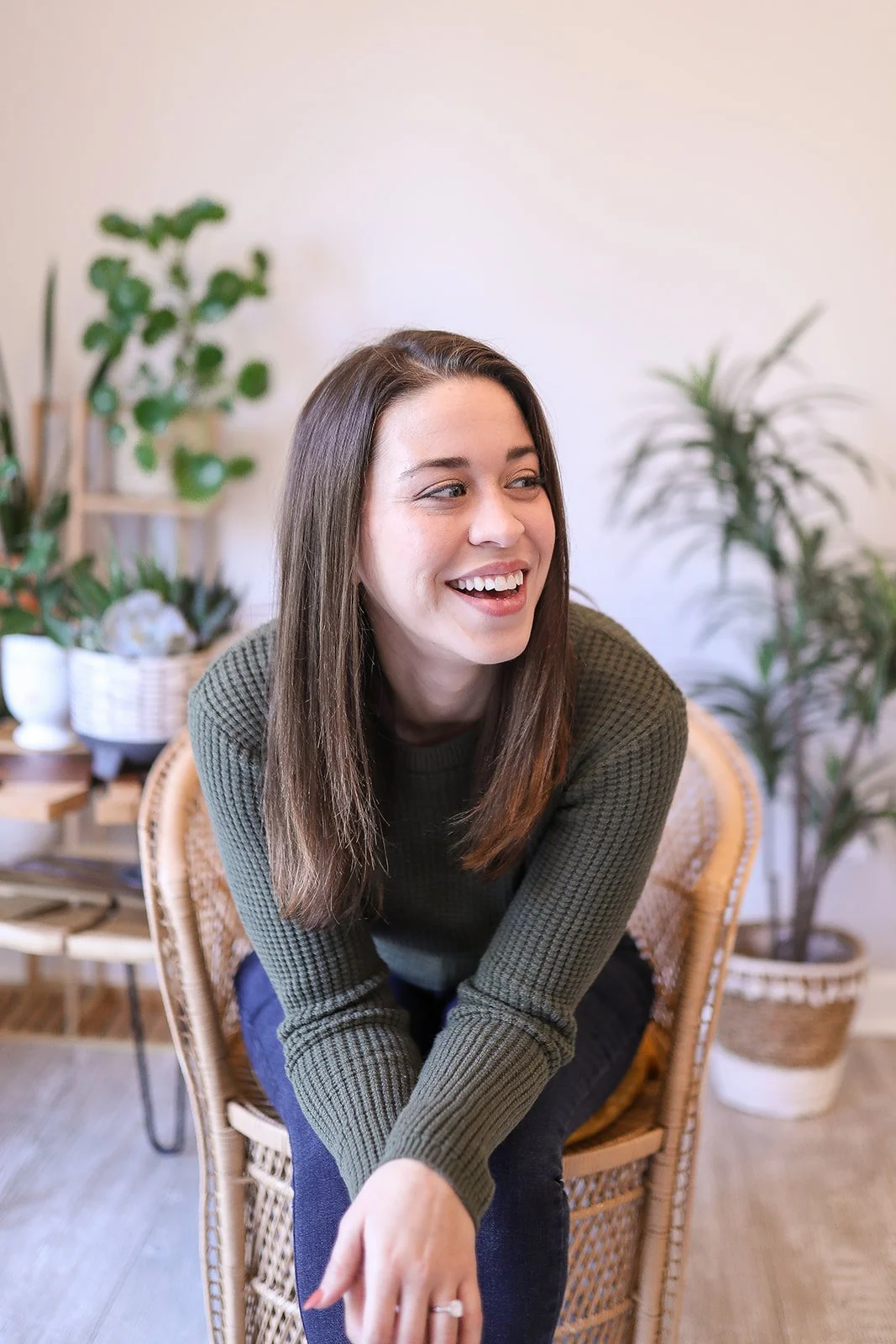 Smiling Samantha of Doula Mae wearing a green sweater