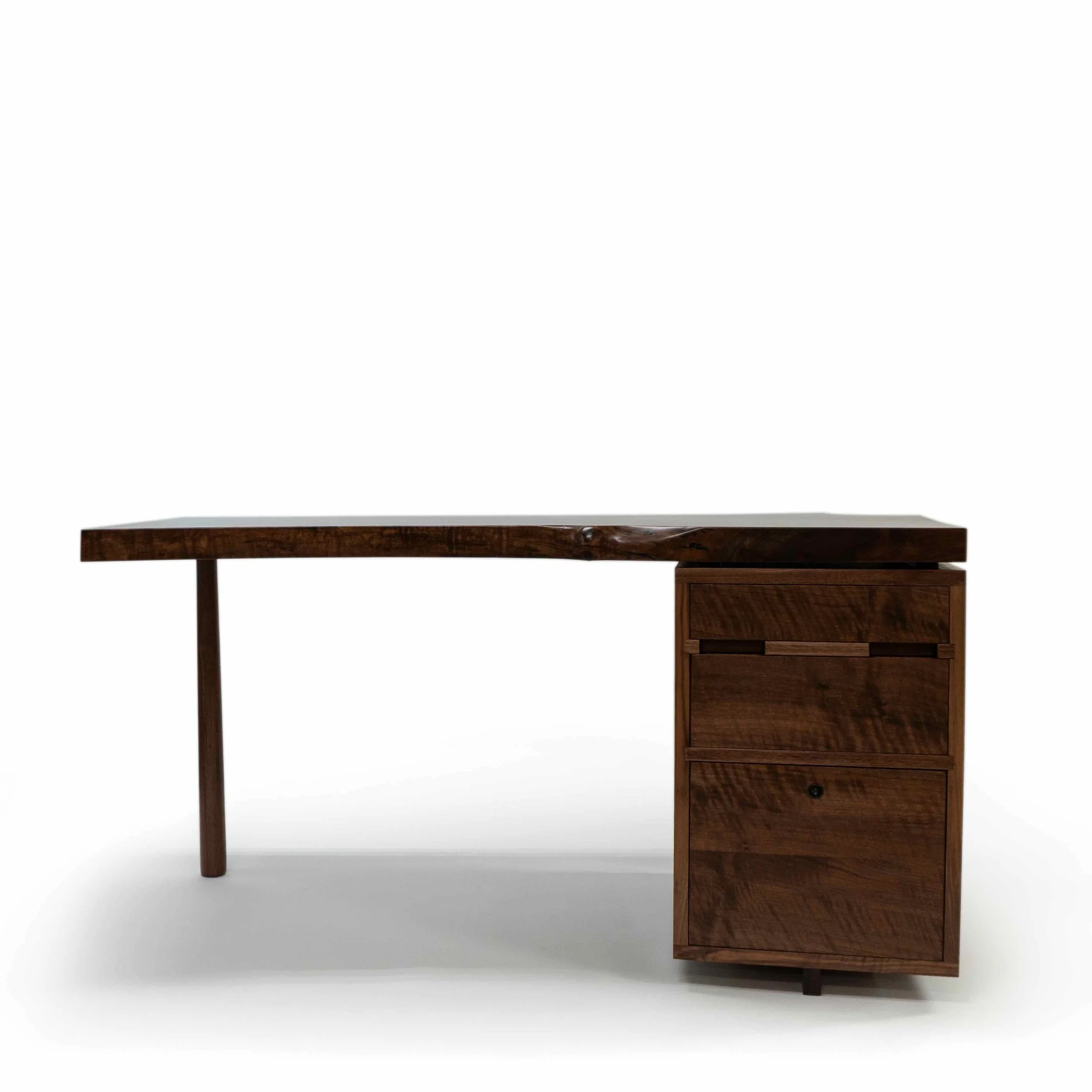 Front of Aurelius Desk in claro walnut slab and black walnut with patinated copper and skull.