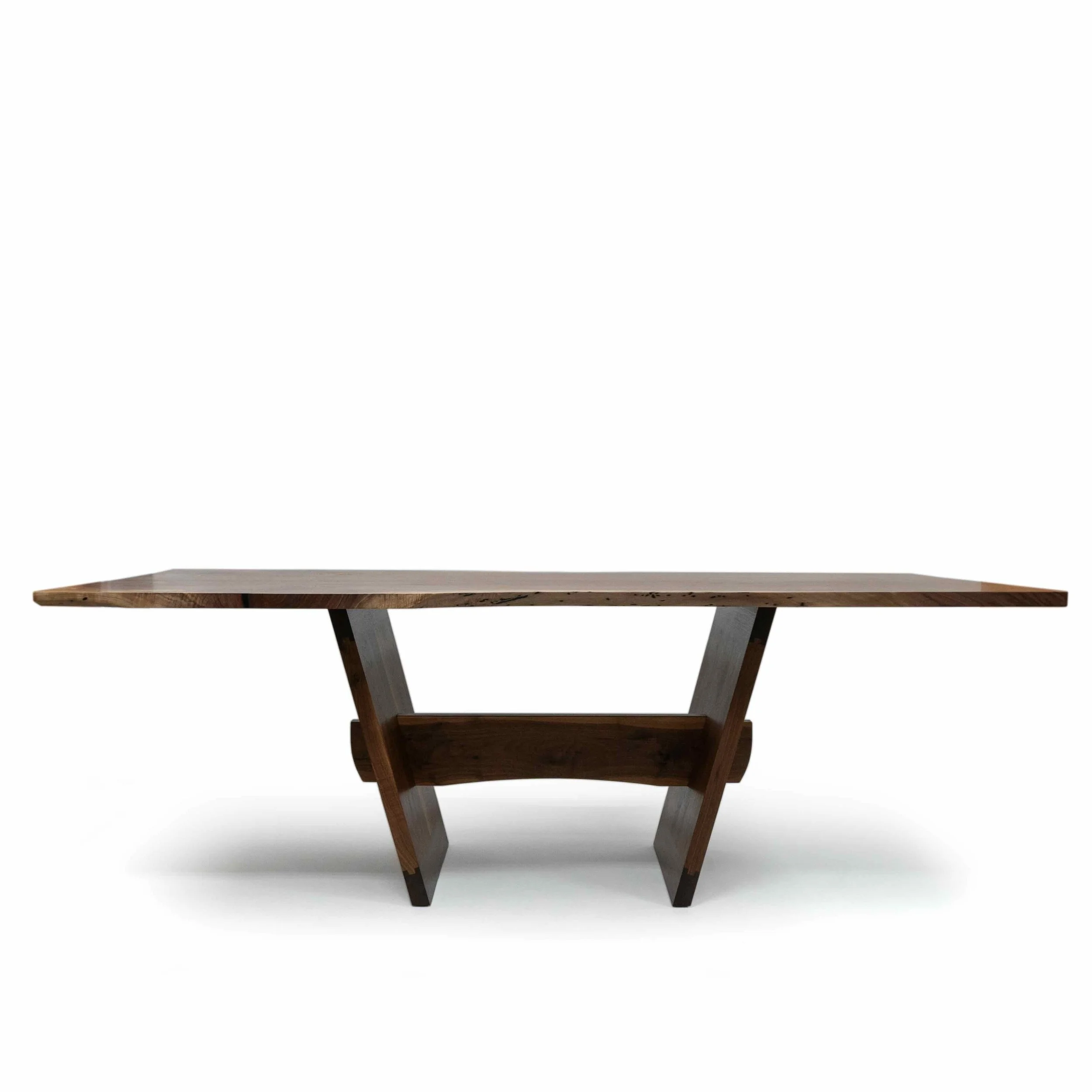 Evocatus dining table in black walnut slab and walnut timber with bubinga and gold leaf.