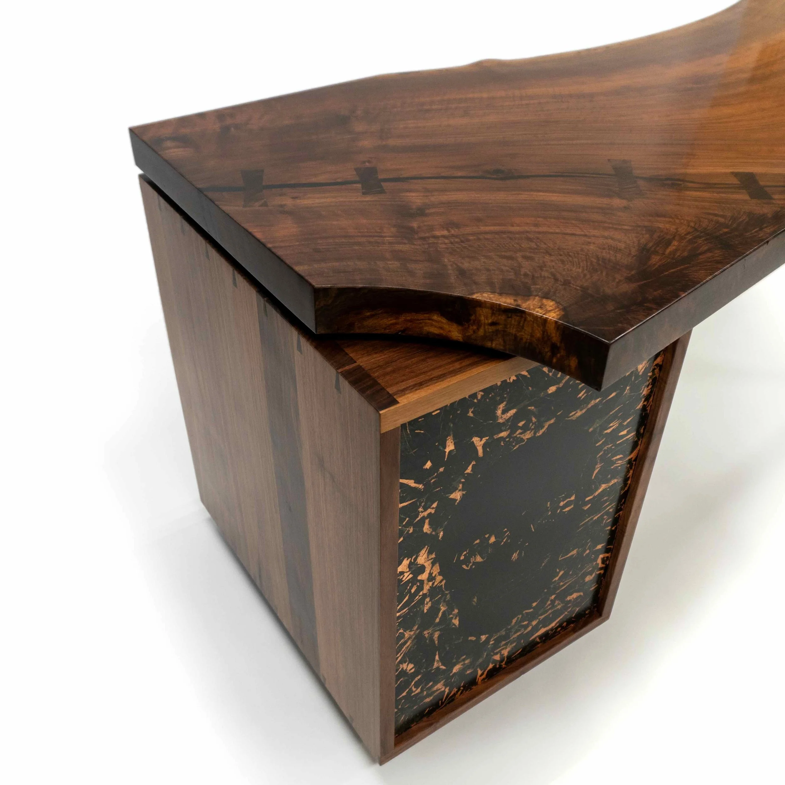 Corner of Aurelius Desk in claro walnut slab and black walnut with patinated copper and skull.