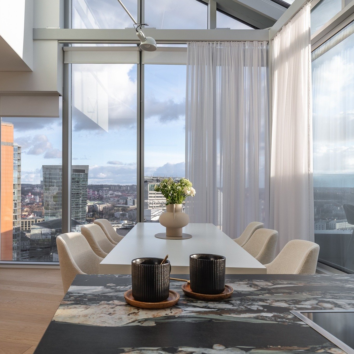 Dining and kitchen zone with a view.
www.aidea.lt - pictures unveiling stories of design. Interior &amp; architecture photography in Lithuania and abroad.
Staging design by: @ievoole @lyg_burtu_lazdele 
.
.
#interiorphotography #interjerofotografas #