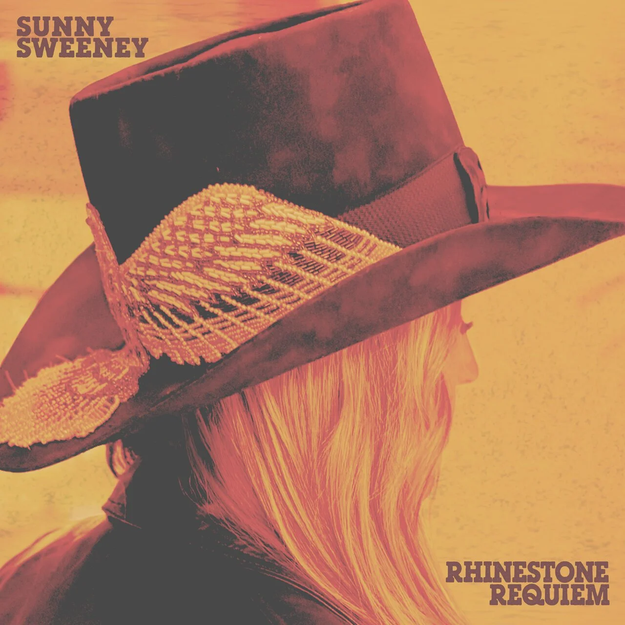 A close up photo of Sunny Sweeney in a cowboy hat looking away from the camera