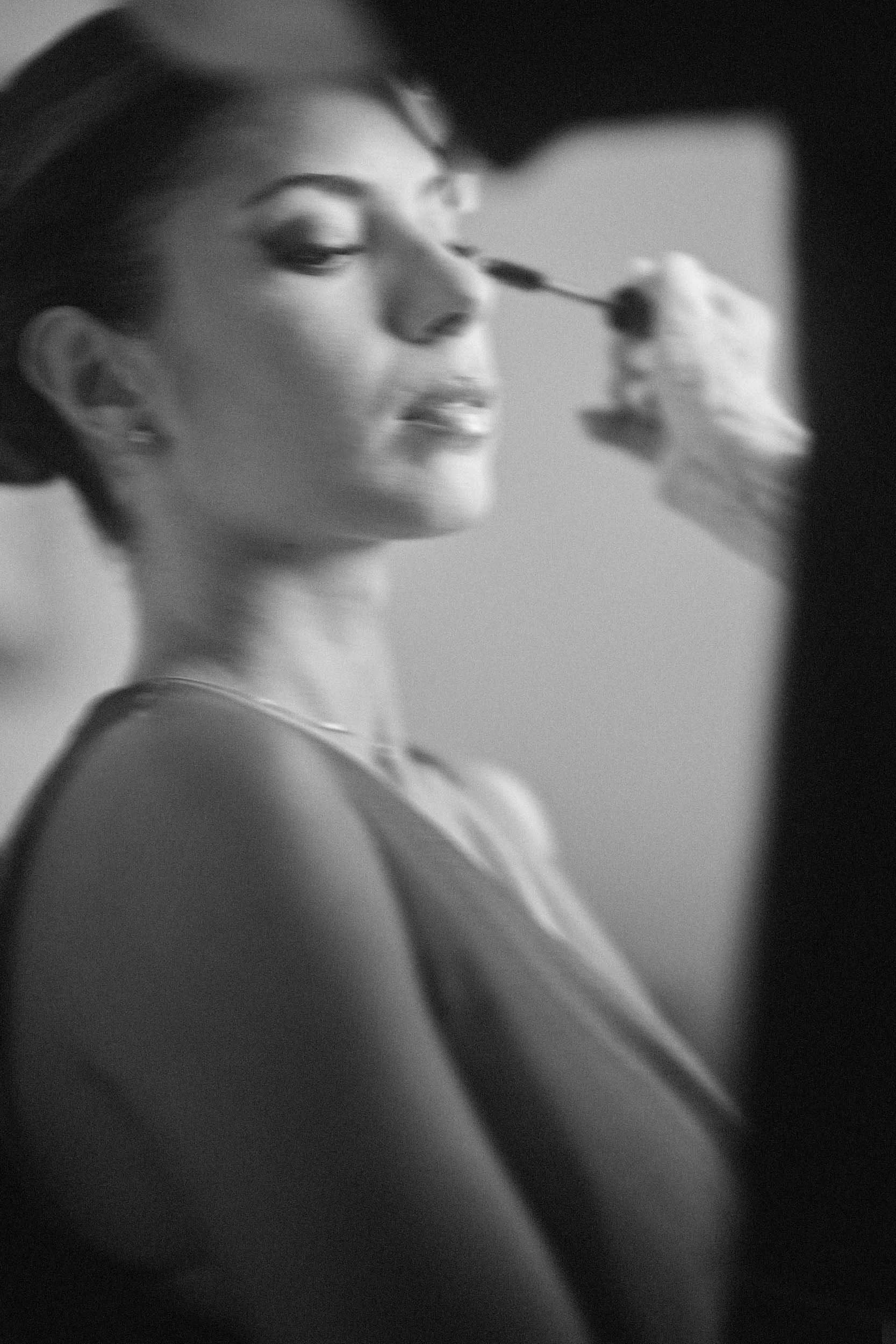 Bride’s sister during getting-ready, motion-blurred in black and white