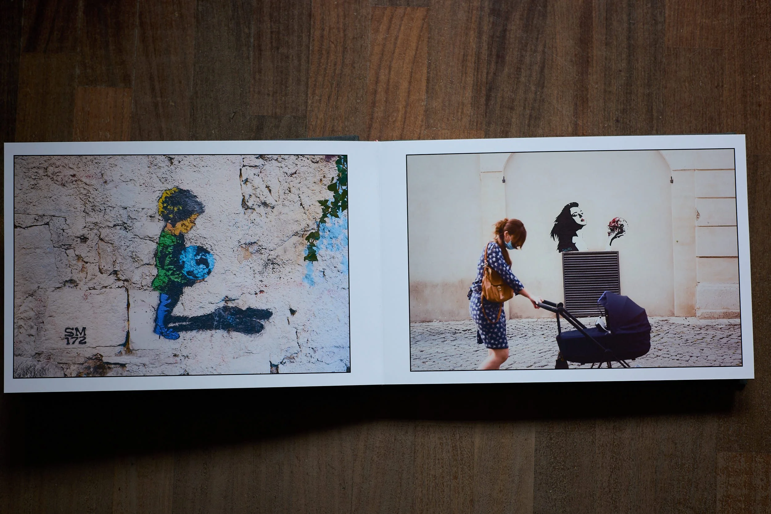 Street fragments (spread) / Book spread showing street art and a woman pushing a stroller on a city street.