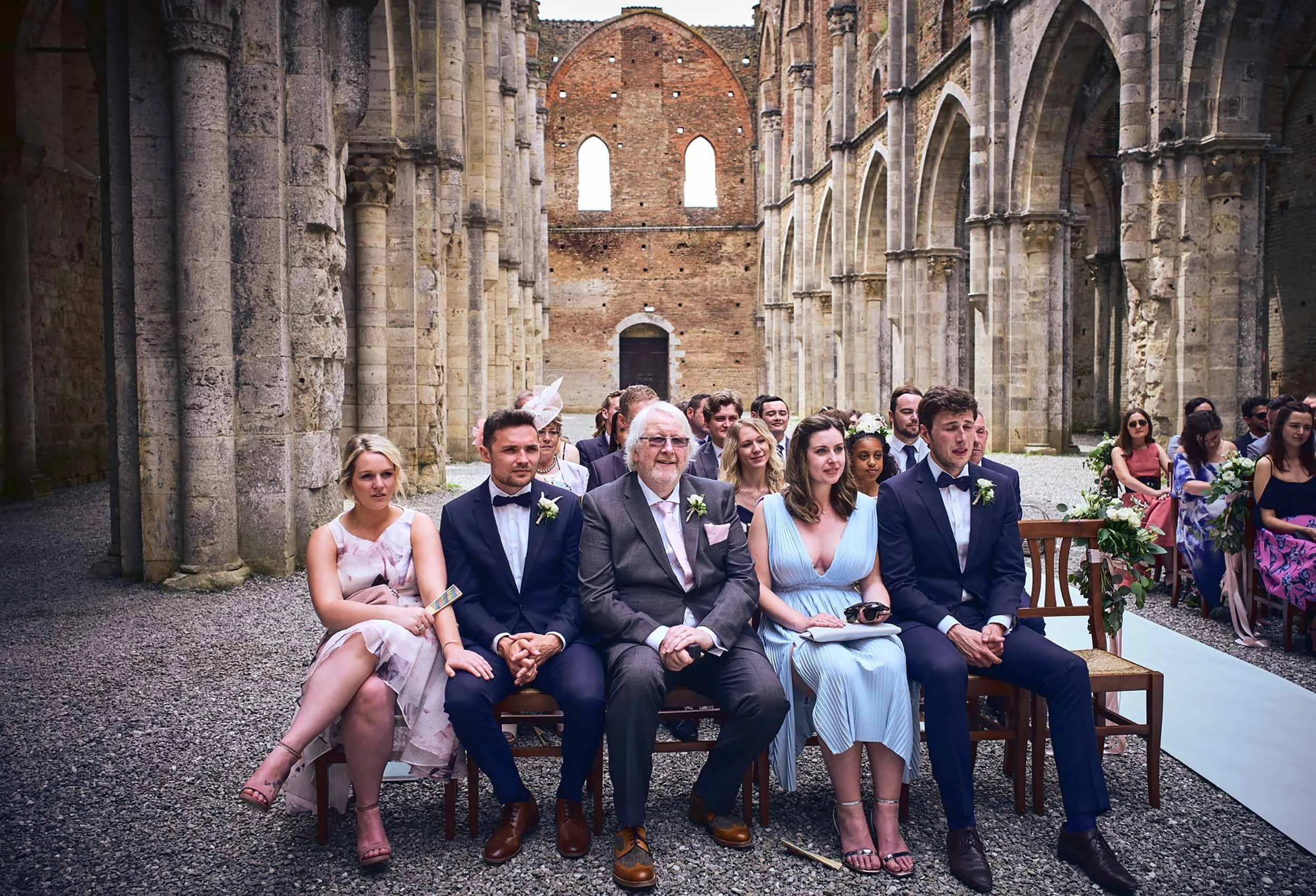 Guests seated inside San Galgano Abbey during the ceremony