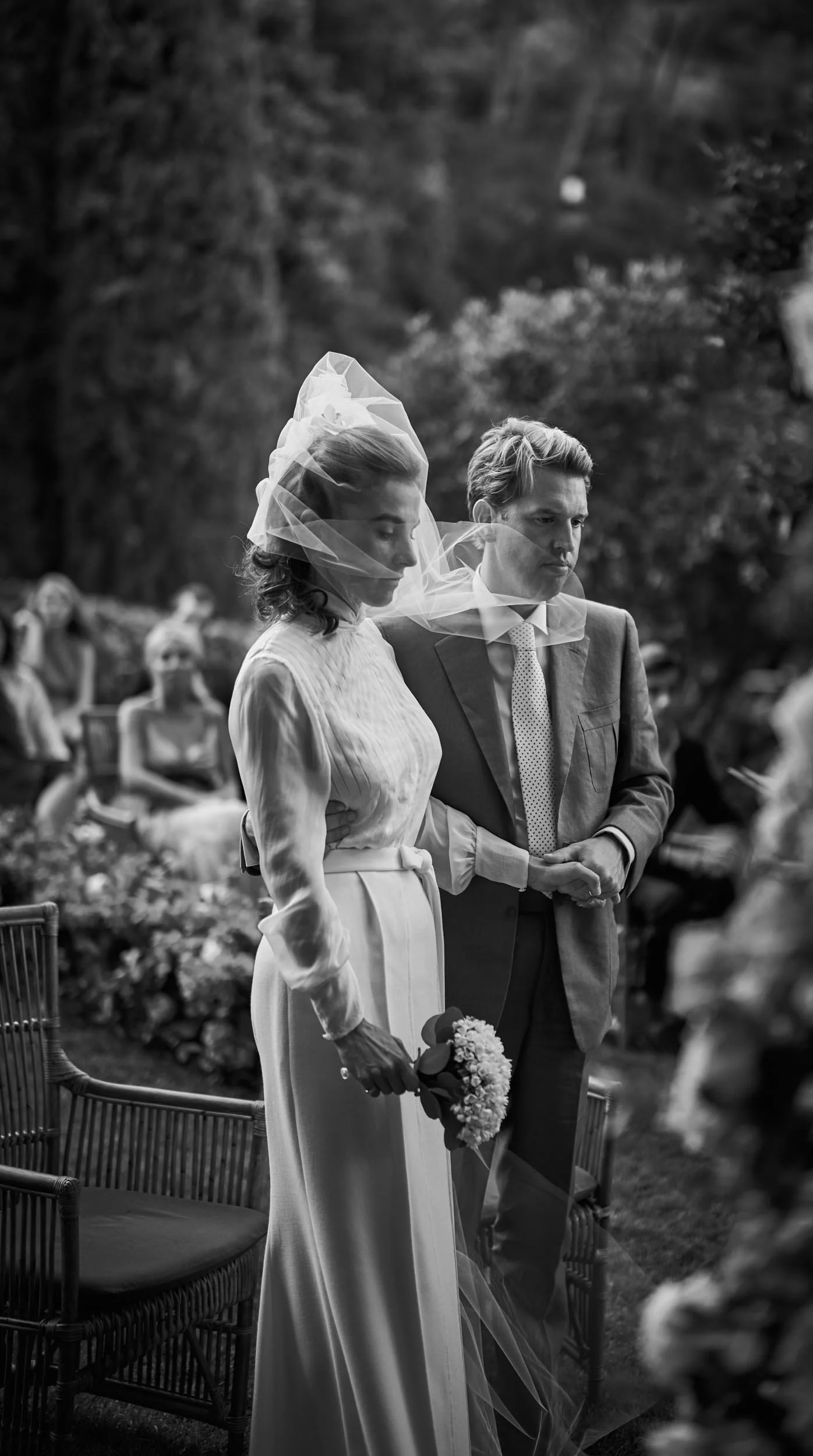 Luxury destination wedding at Hotel Il Pellicano — bride and groom at the ceremony, veil in the wind (black and white).