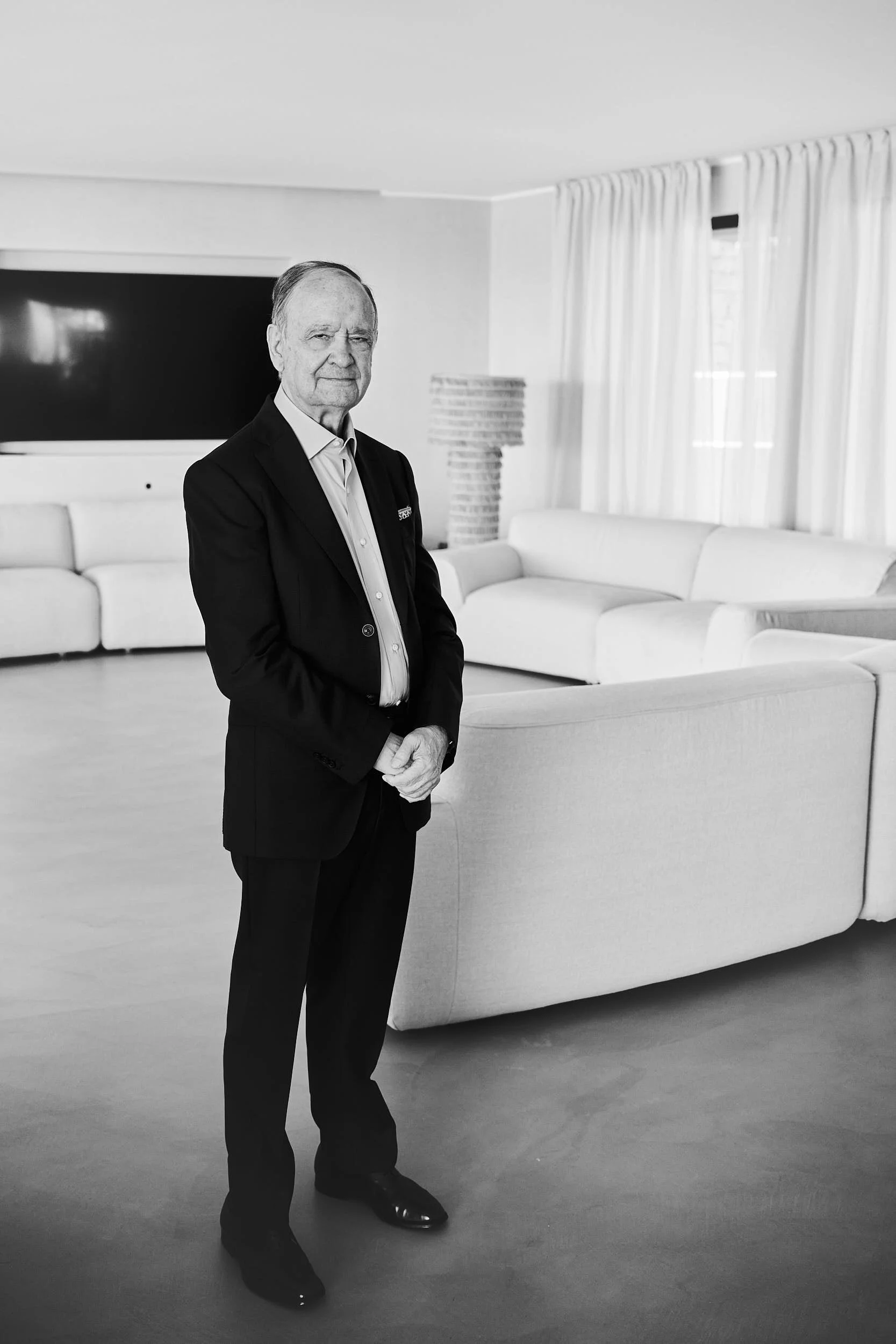 Grandfather of the bride in a suit, portrait inside a modern private villa in Sardinia.