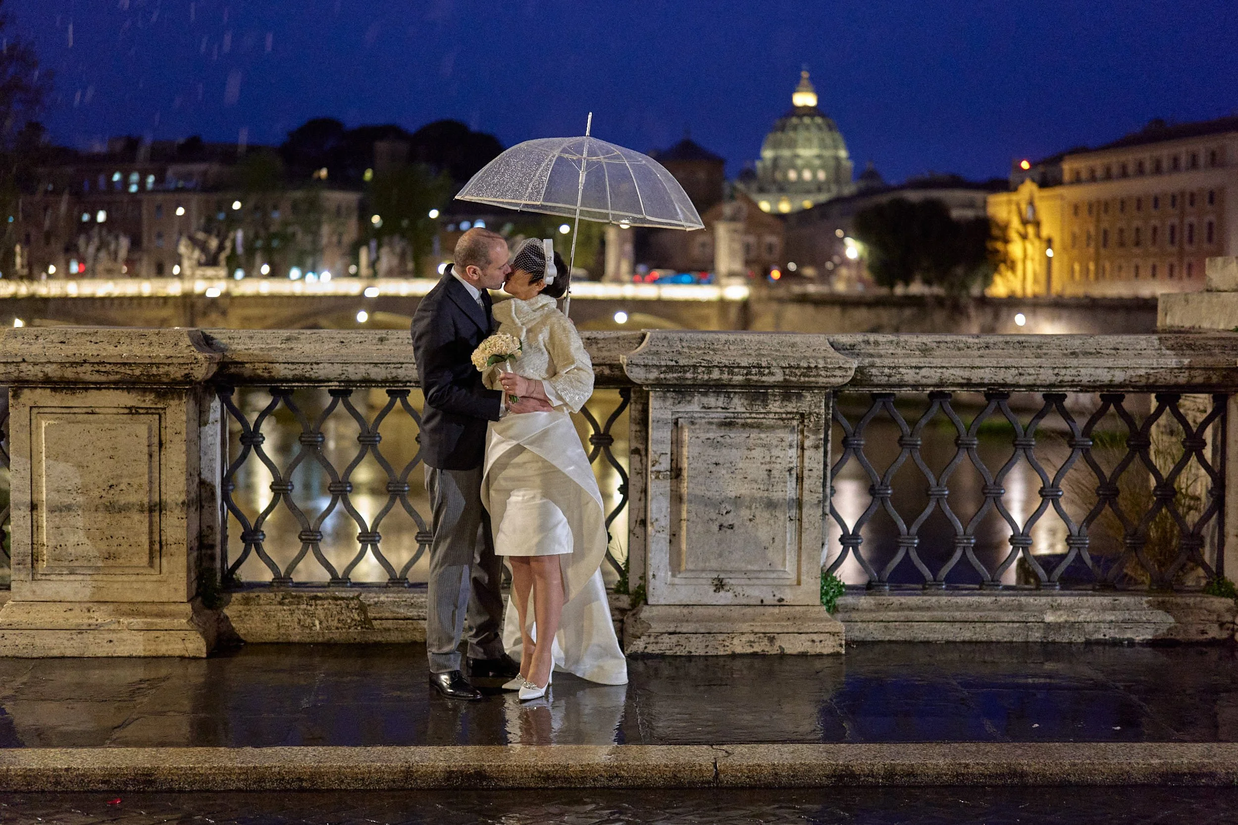 Bride and groom kissing at blue hour with St Peter’s in the background