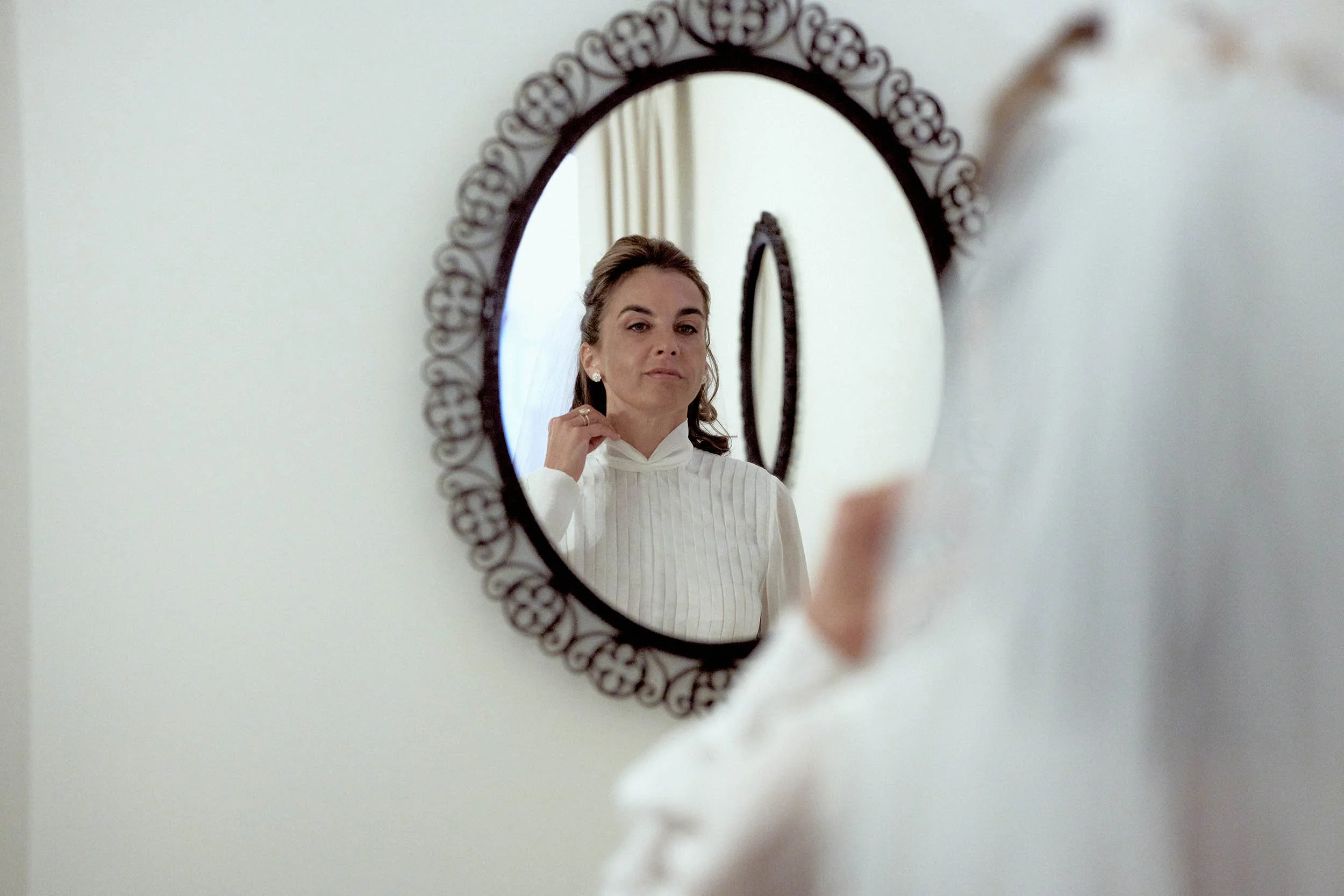 bride getting ready, reflected in the mirror at Hotel Il Pellicano.