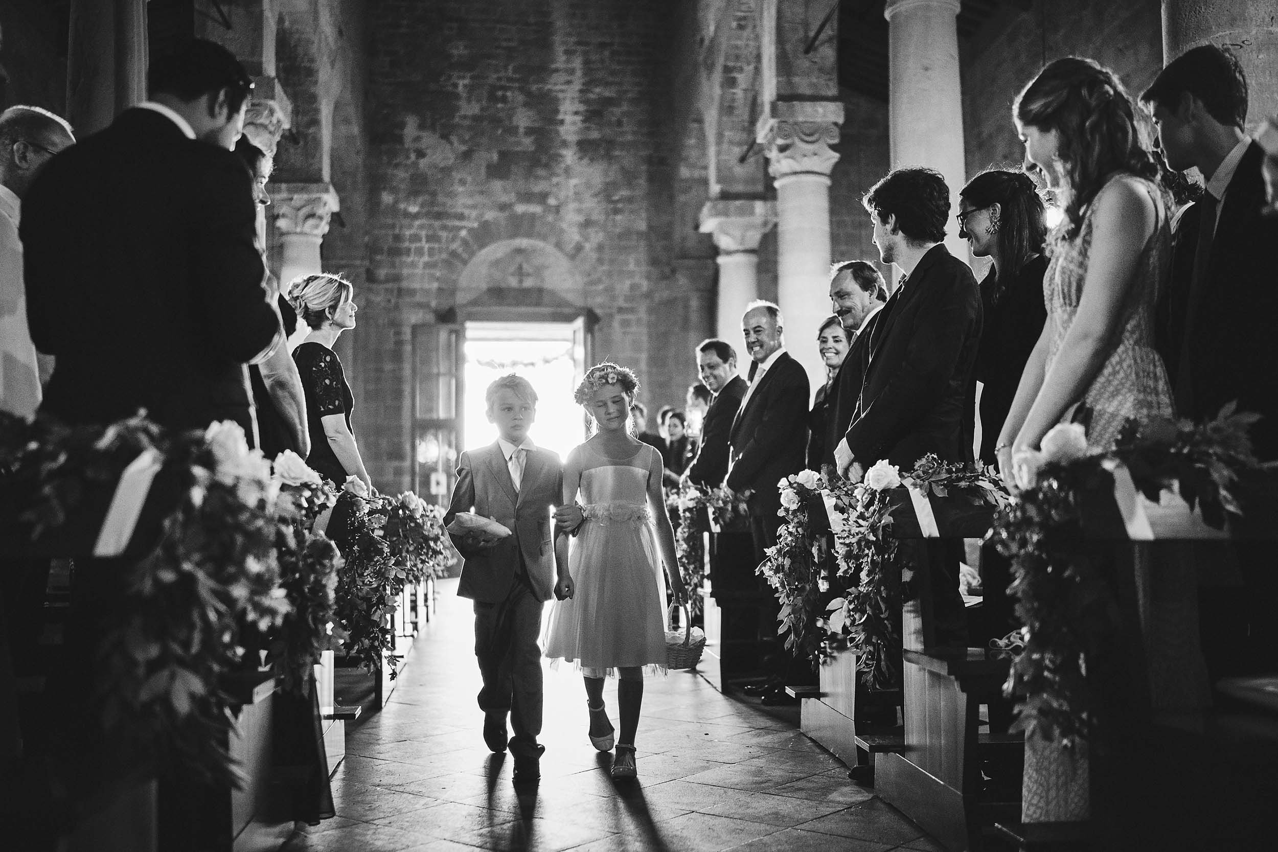 The son and daughter bring the rings to the altar. Destination Wedding in Tuscany. Black and White