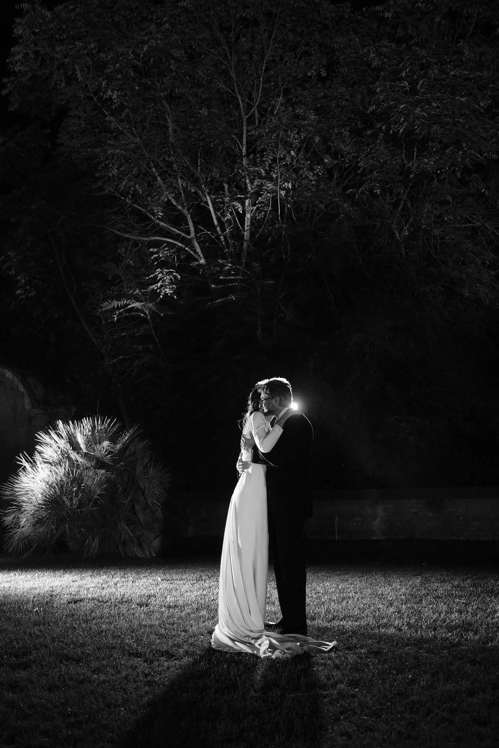 Bride and Groom first dance at night, backlight, black and white destination wedding photography.