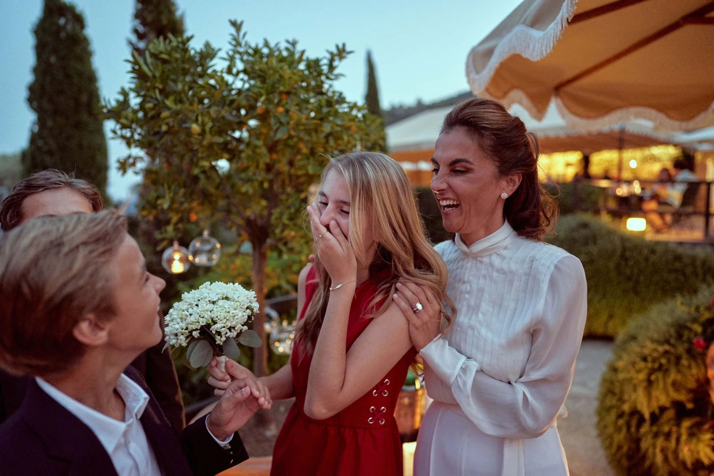 niece receives the bouquet, joyful moment at the reception.