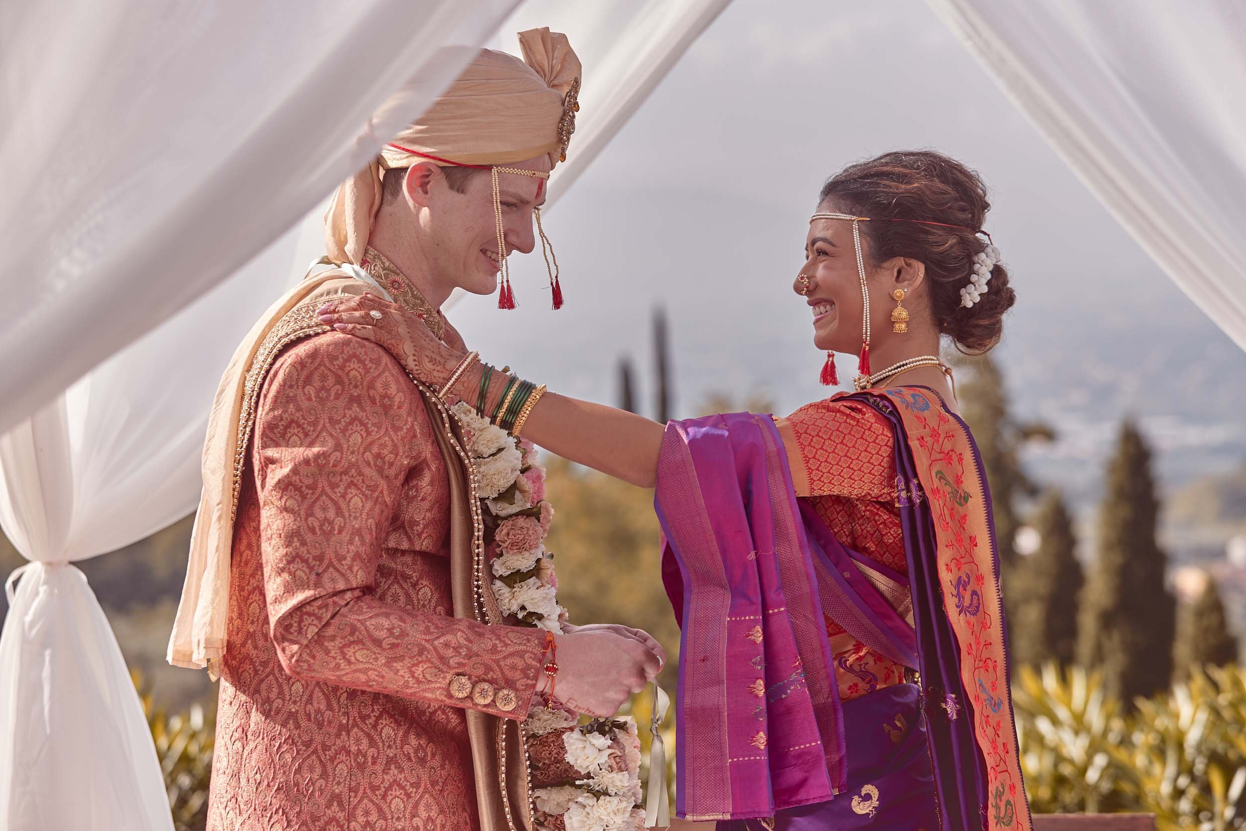Bride and groom exchanging flower garlands