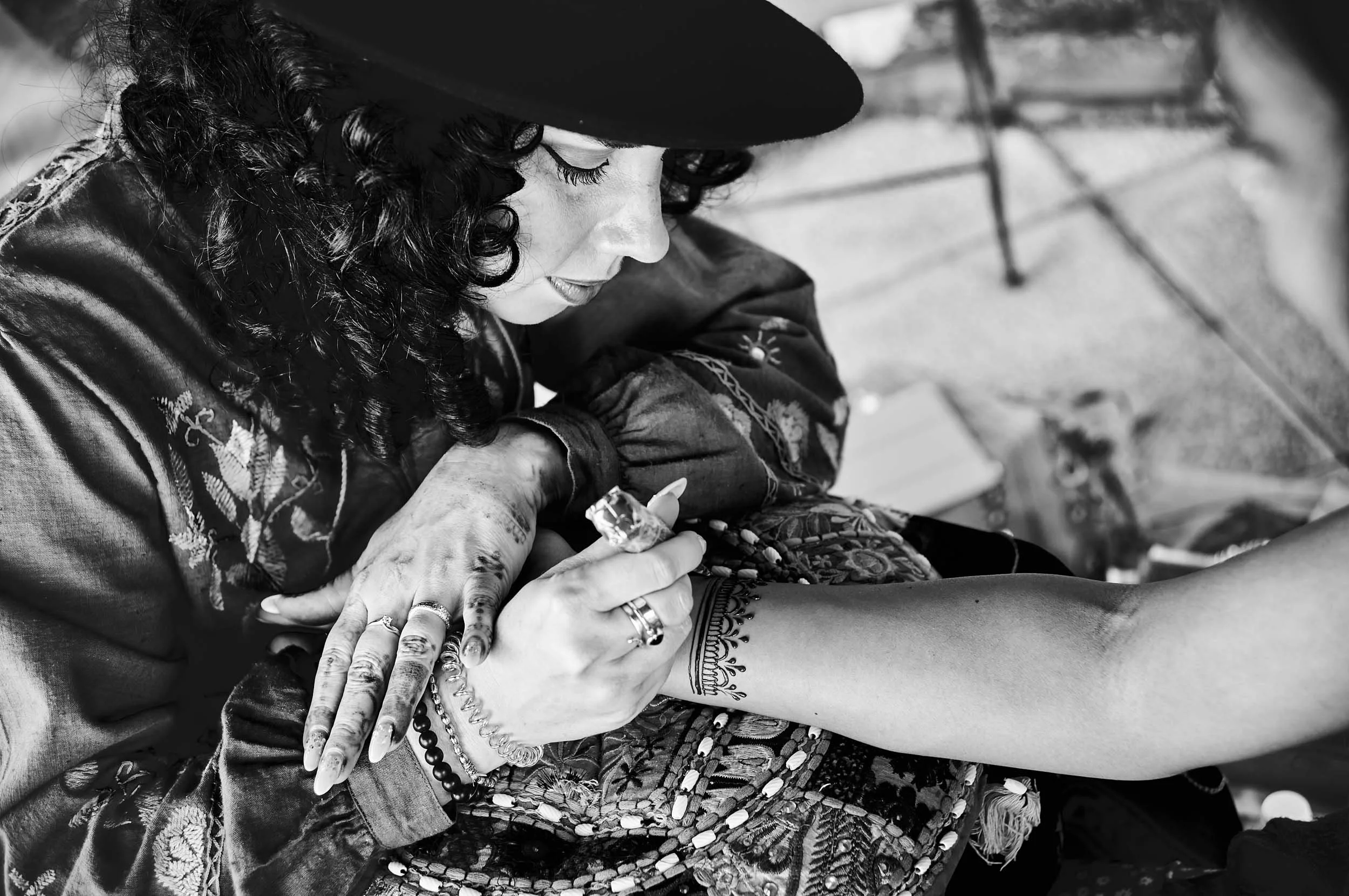 Henna artist finishing the ritual