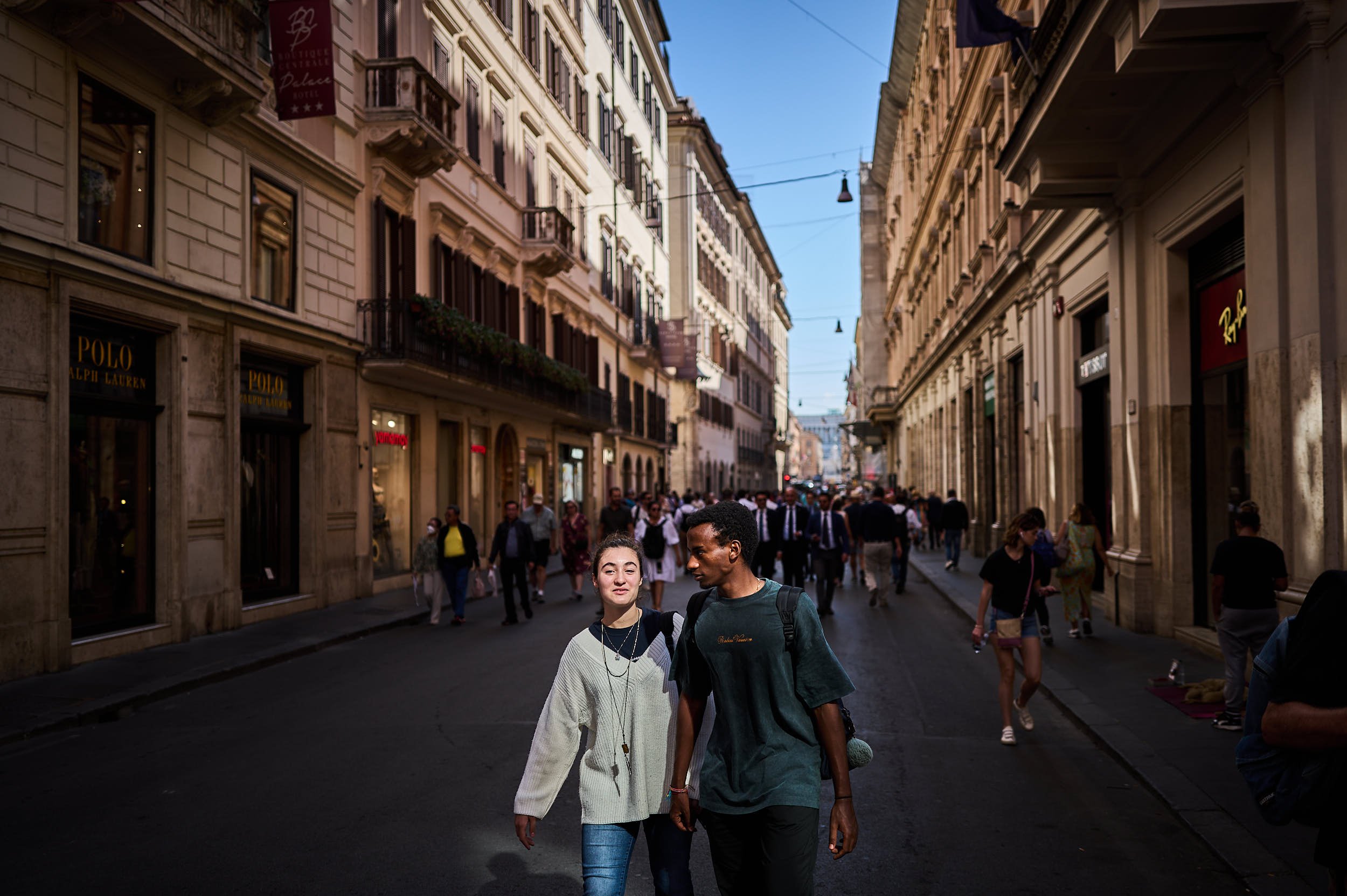 A young couple walking in via del Corso, Rome