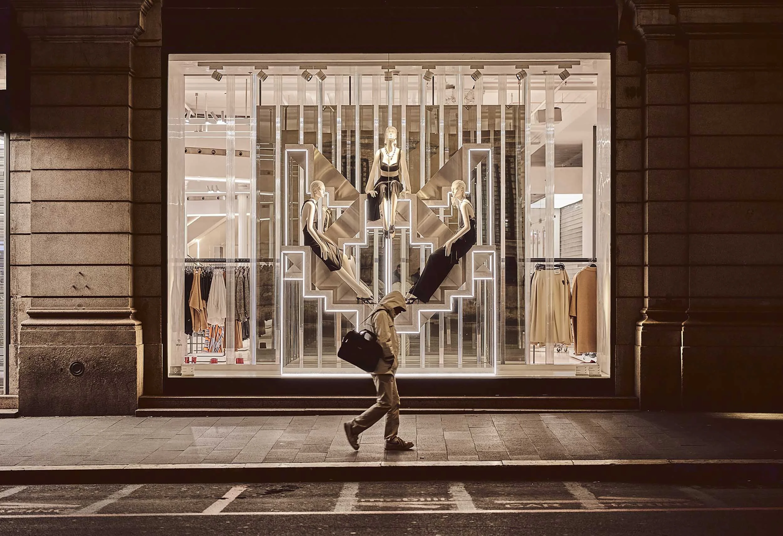 Man walking alone at night in Via del Corso, Rome