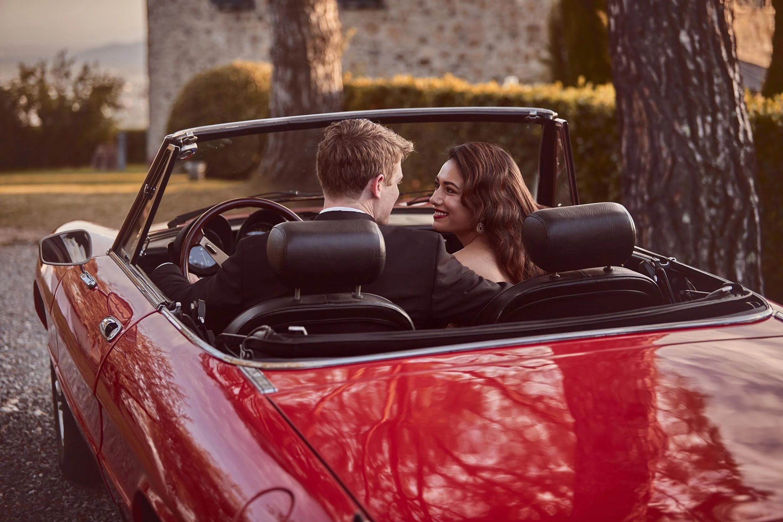 Bride looking at the groom in the car