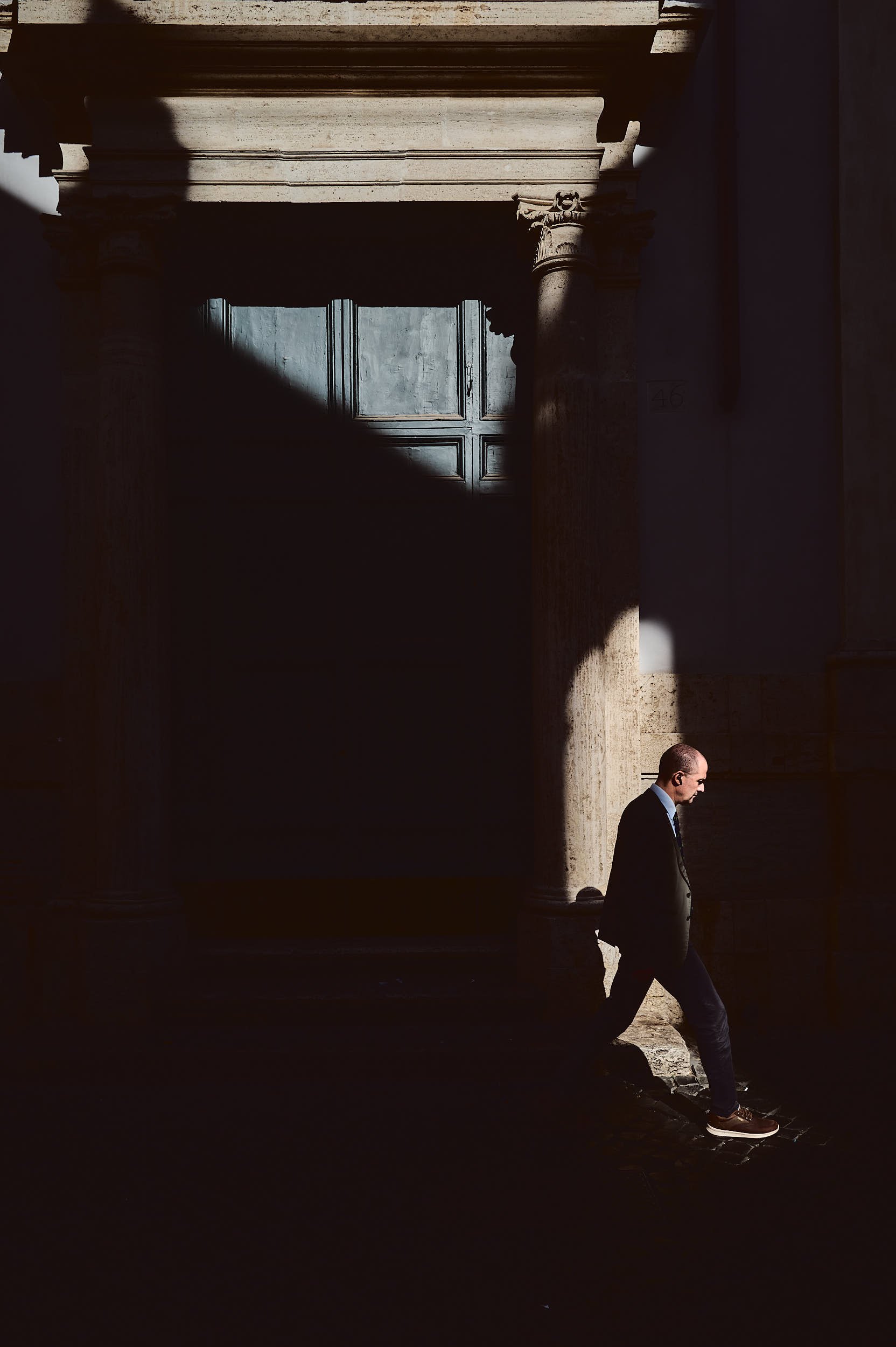 A man walking in front of an historic church in Rome