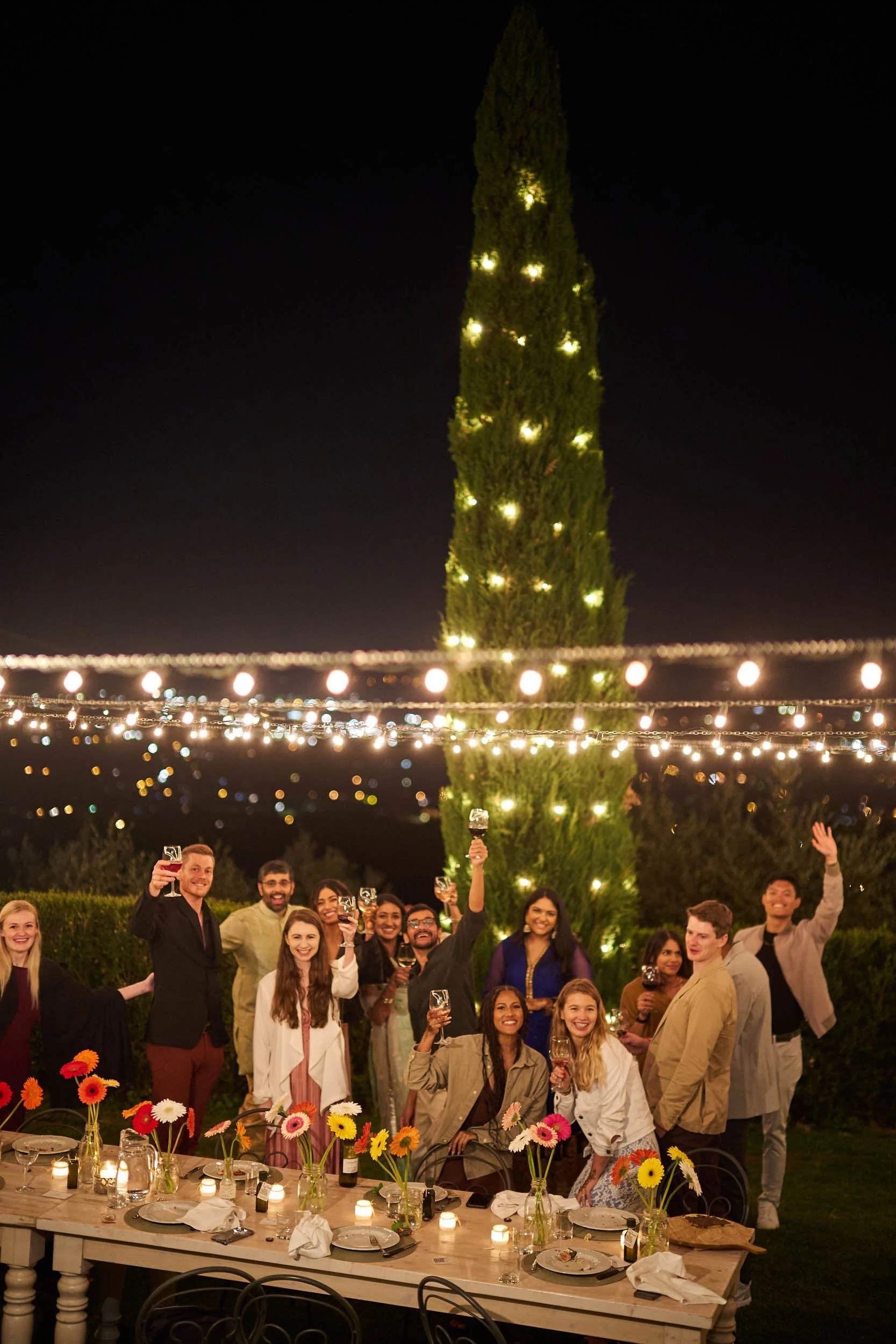 Bride, groom, and guests toasting at the end of the first evening