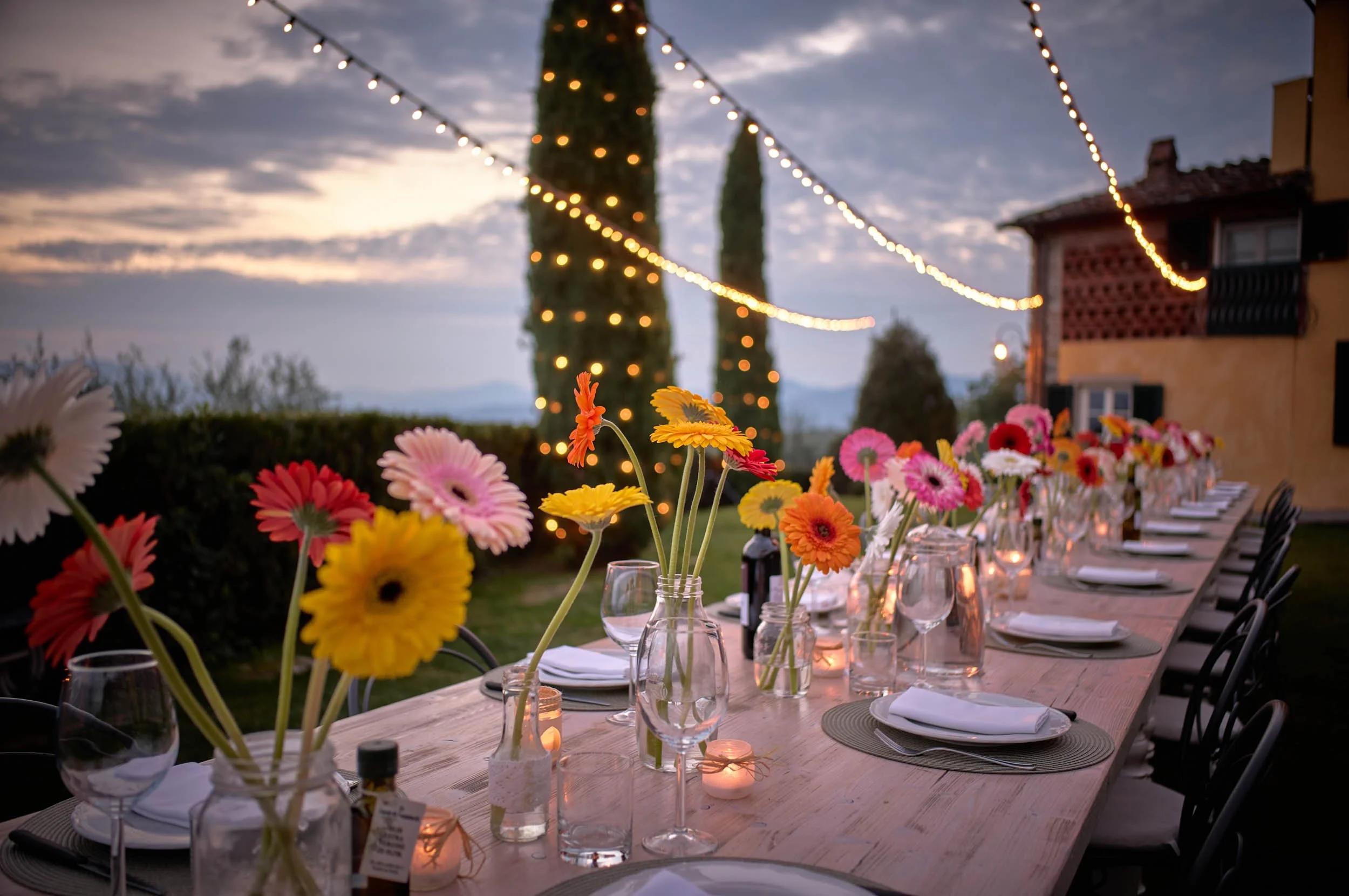 Colorful dinner setup with flowers and warm lights