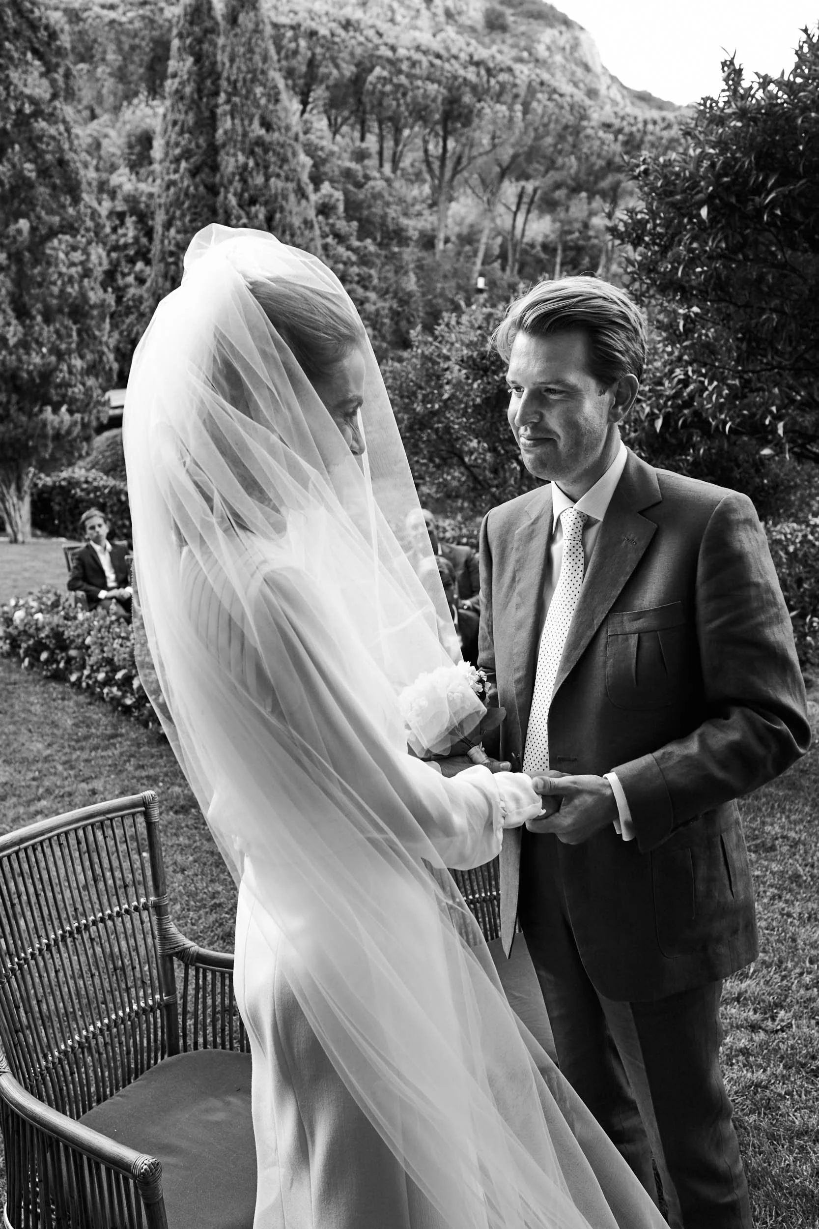 Hotel Il Pellicano, Porto Ercole — bride and groom smiling at each other, wind-blown veil.