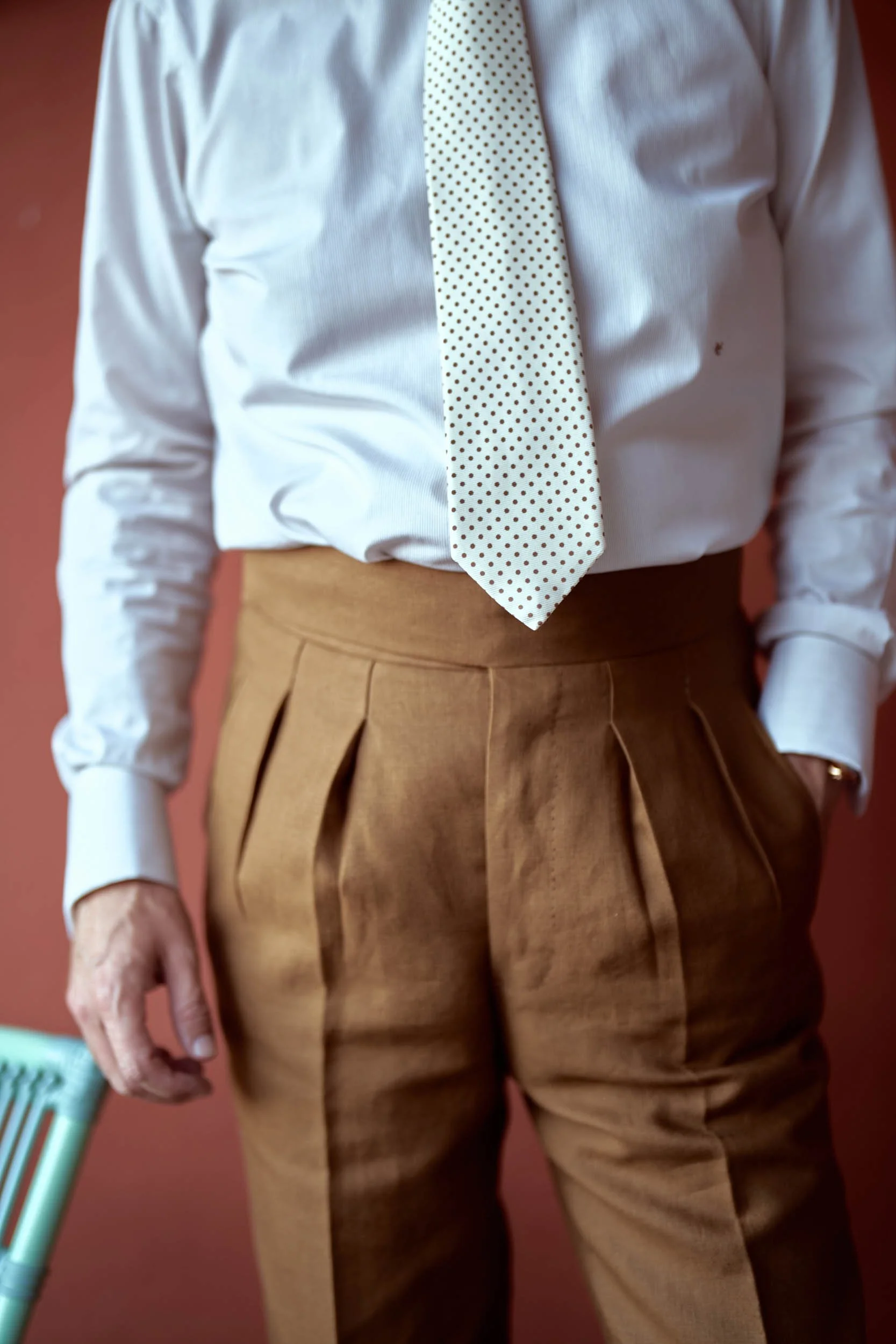 Groom outfit detail with tie and pleated trousers at Hotel Il Pellicano.