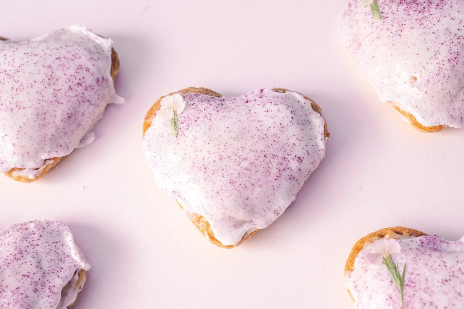 Heart-shaped Ube Coconut Hand Pies from Pop Pie Co. in San Diego, decorated with flowers and glazed for Mother’s Day.