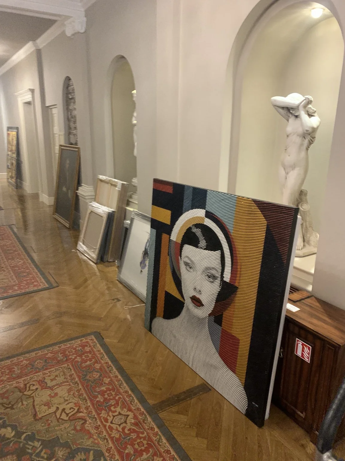 Framed artwork and sculpture displayed in gallery ready for specialist art transport service