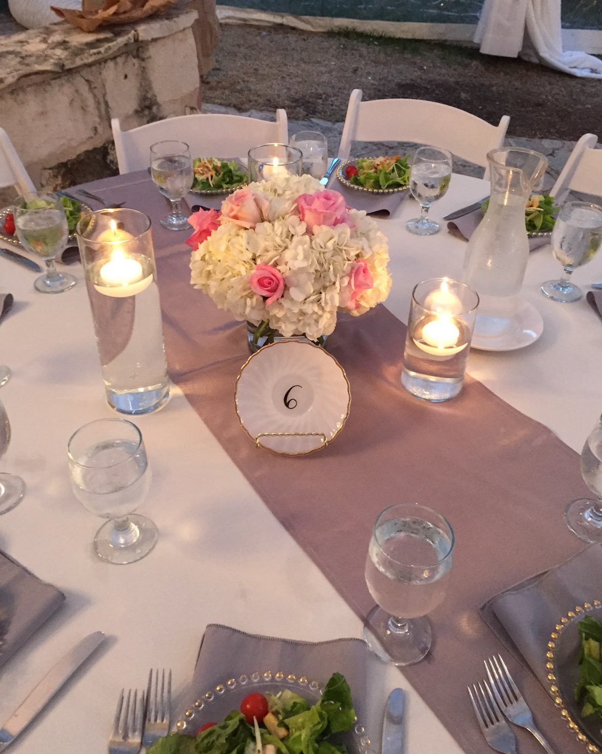 A table at a wedding decorated with a flower arrangement centerpiece