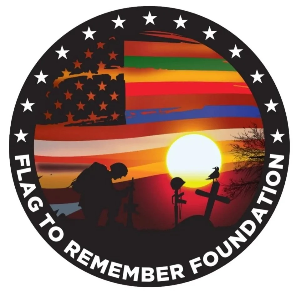 A memorial patch featuring a silhouette of a soldier kneeling by crosses, with a sunset and American flag in the background, and the text 'Flag to Remember Foundation' around the border.
