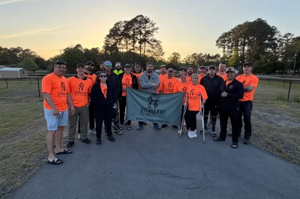 Group of LWO core walkers holding the Let's Walk It Out banner