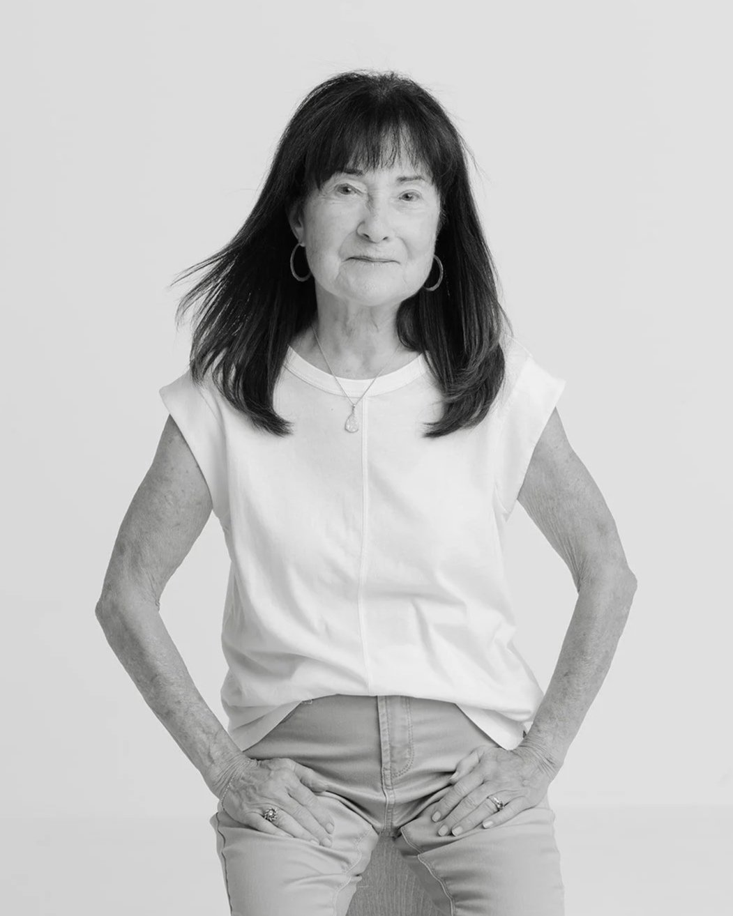 Black and white studio portrait of Jackie Cole standing confidently during her 50 Women Project photoshoot with Christine Harris.